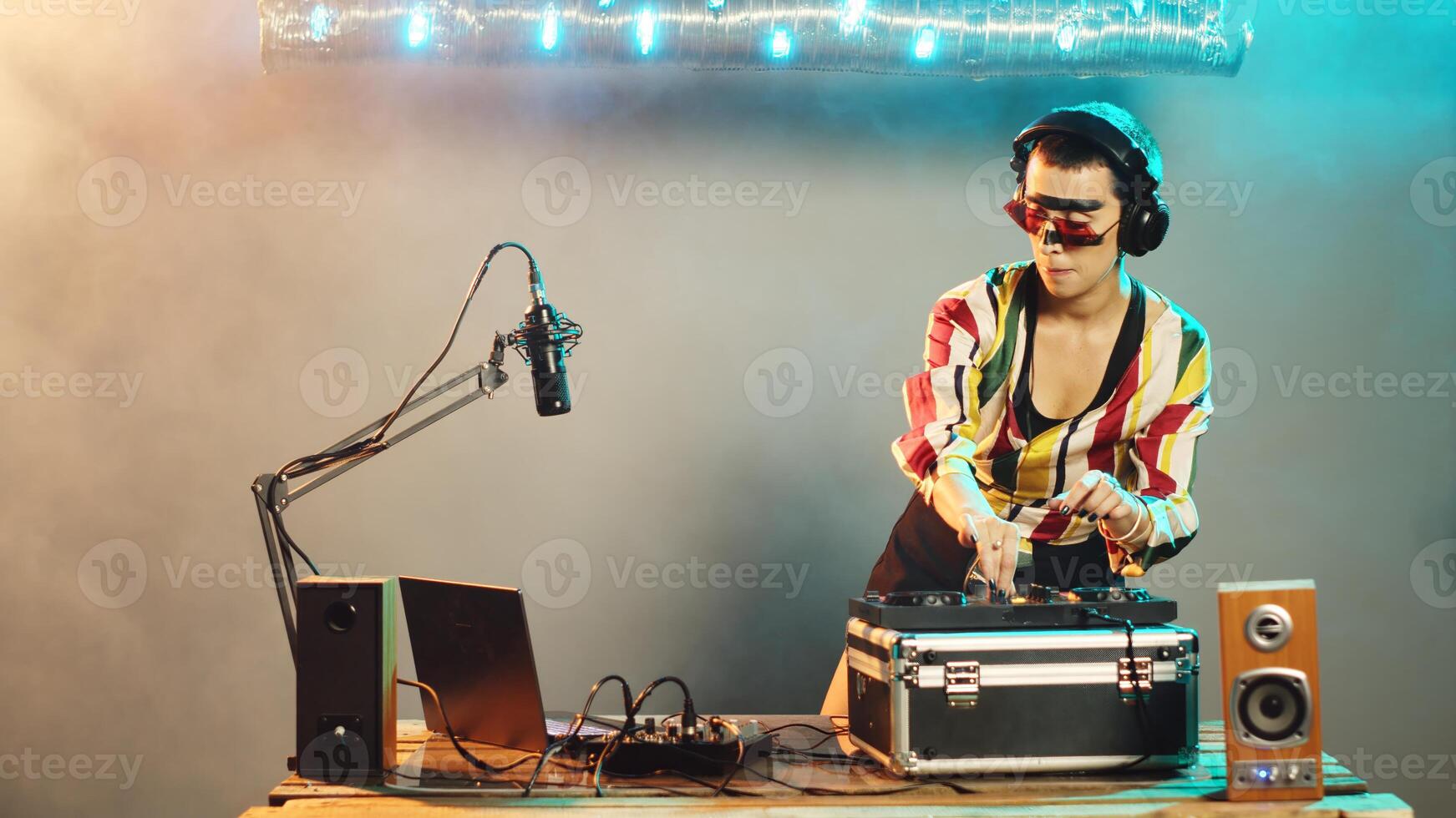 Woman performer hiding from police after seeing lights at nightclub, trying to stop techno party after hearing sirens. Female DJ running from law enforcement raid. Tripod shot. photo