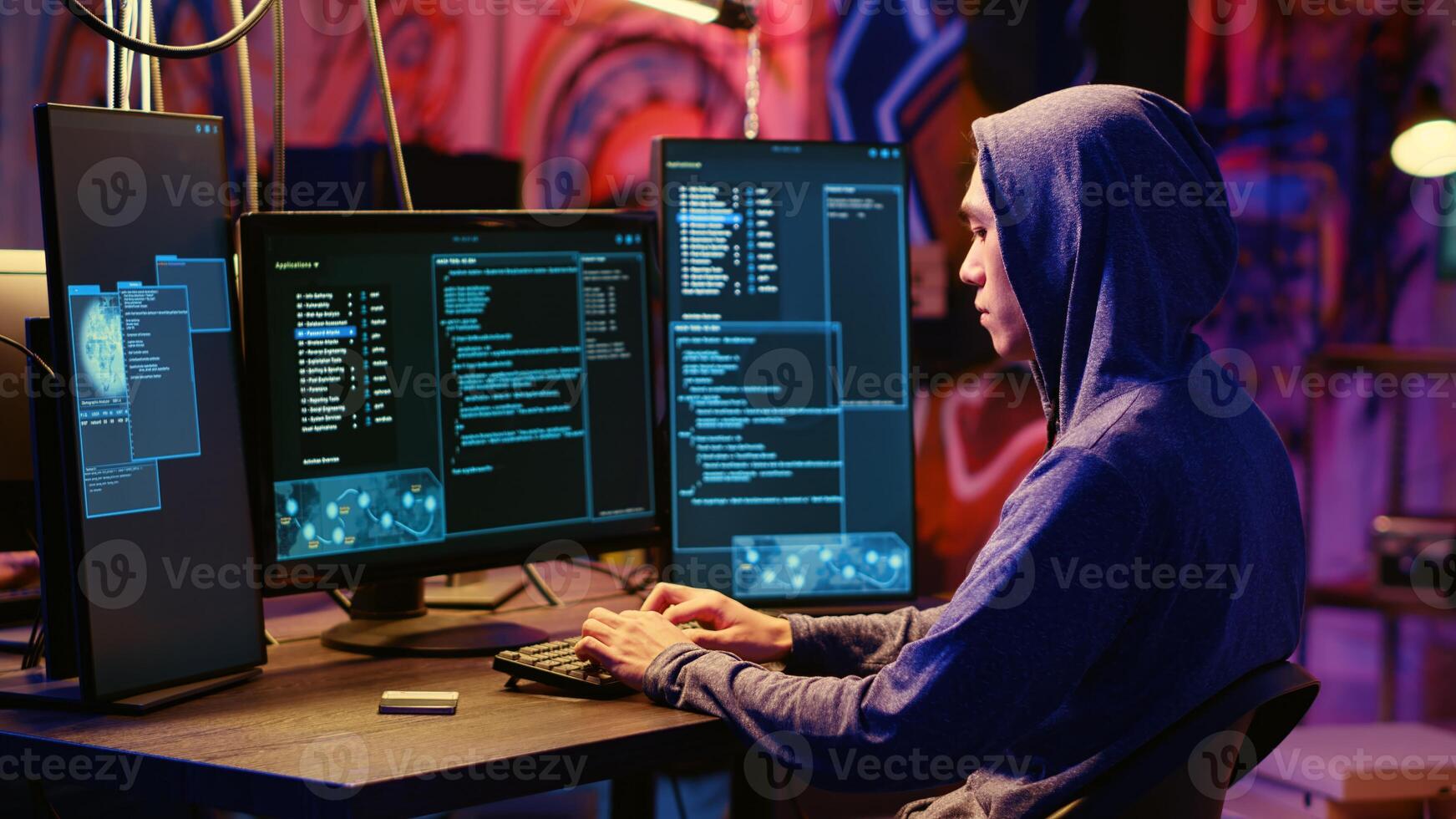 Hacker in hidden underground base able to successfully get past anti tamper measures implemented by companies to protect their software, uploading finished crack on SSD, ready to sell it online photo