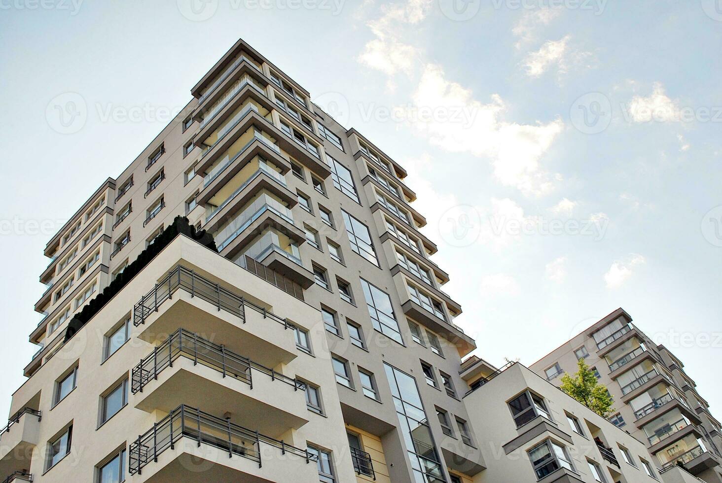 Modern apartment building in sunny day. Exterior, residential house facade. photo