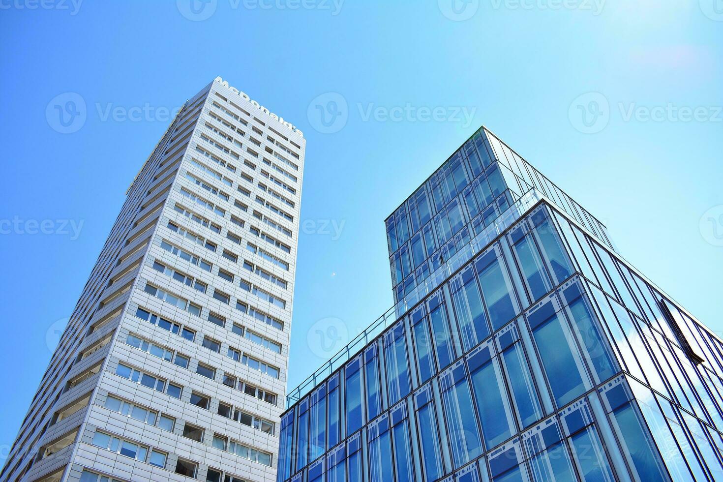 Glass building with transparent facade of the building and blue sky. Structural glass wall reflecting blue sky. Abstract modern architecture fragment. Contemporary architectural background. photo