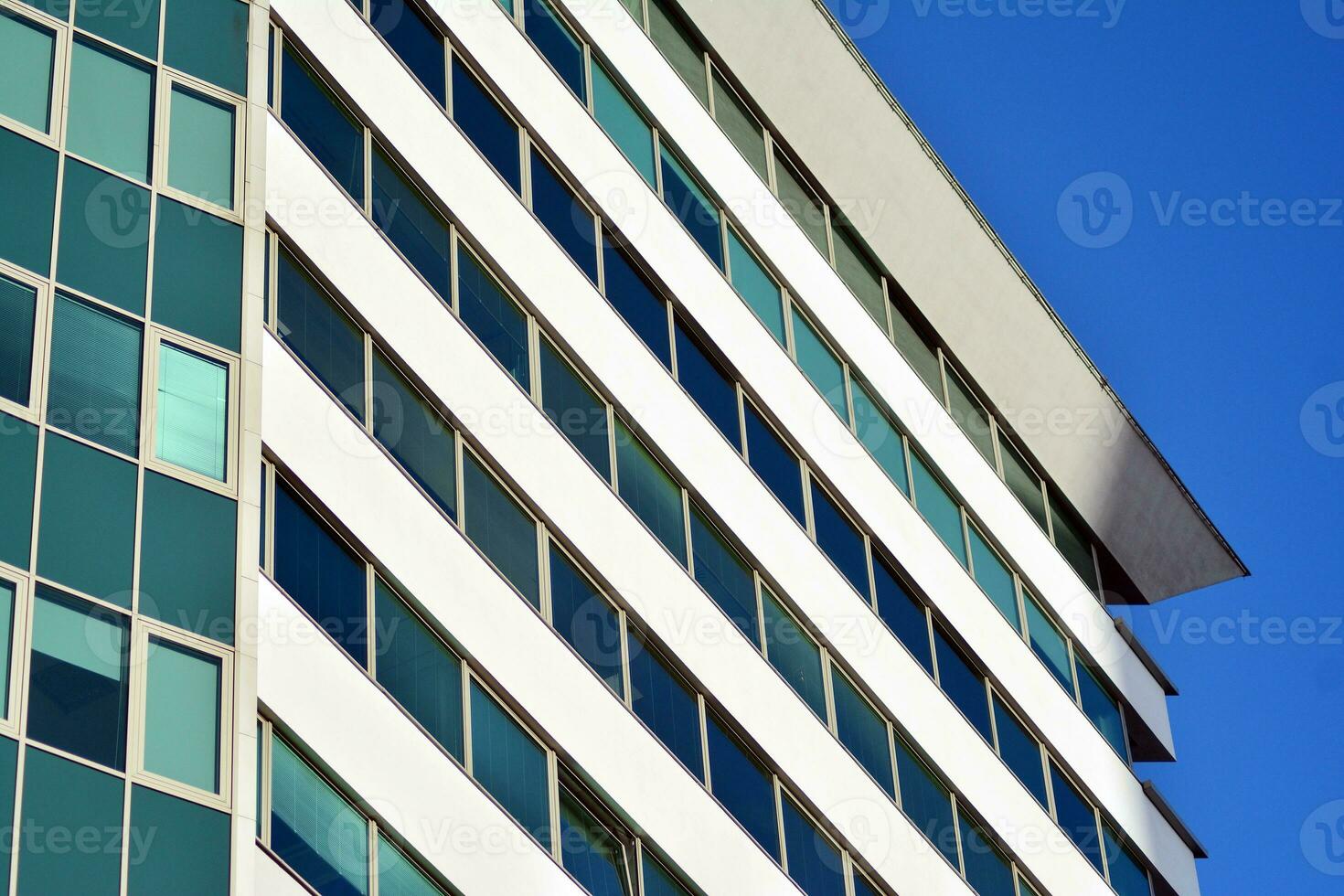 Glass building with transparent facade of the building and blue sky. Structural glass wall reflecting blue sky. photo