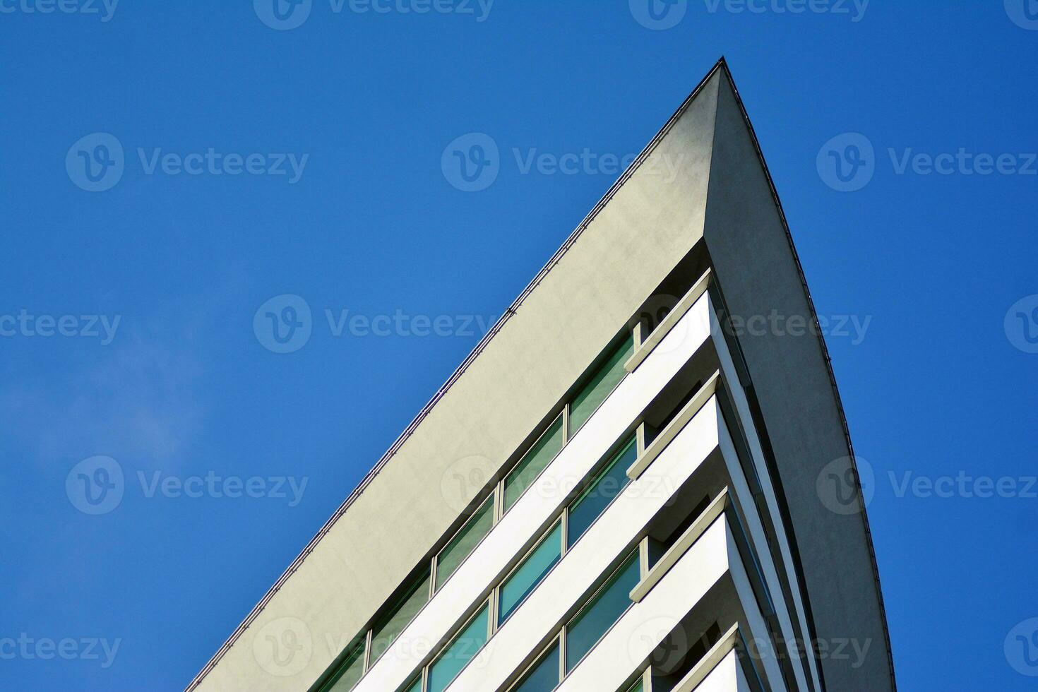 Glass building with transparent facade of the building and blue sky. Structural glass wall reflecting blue sky. photo