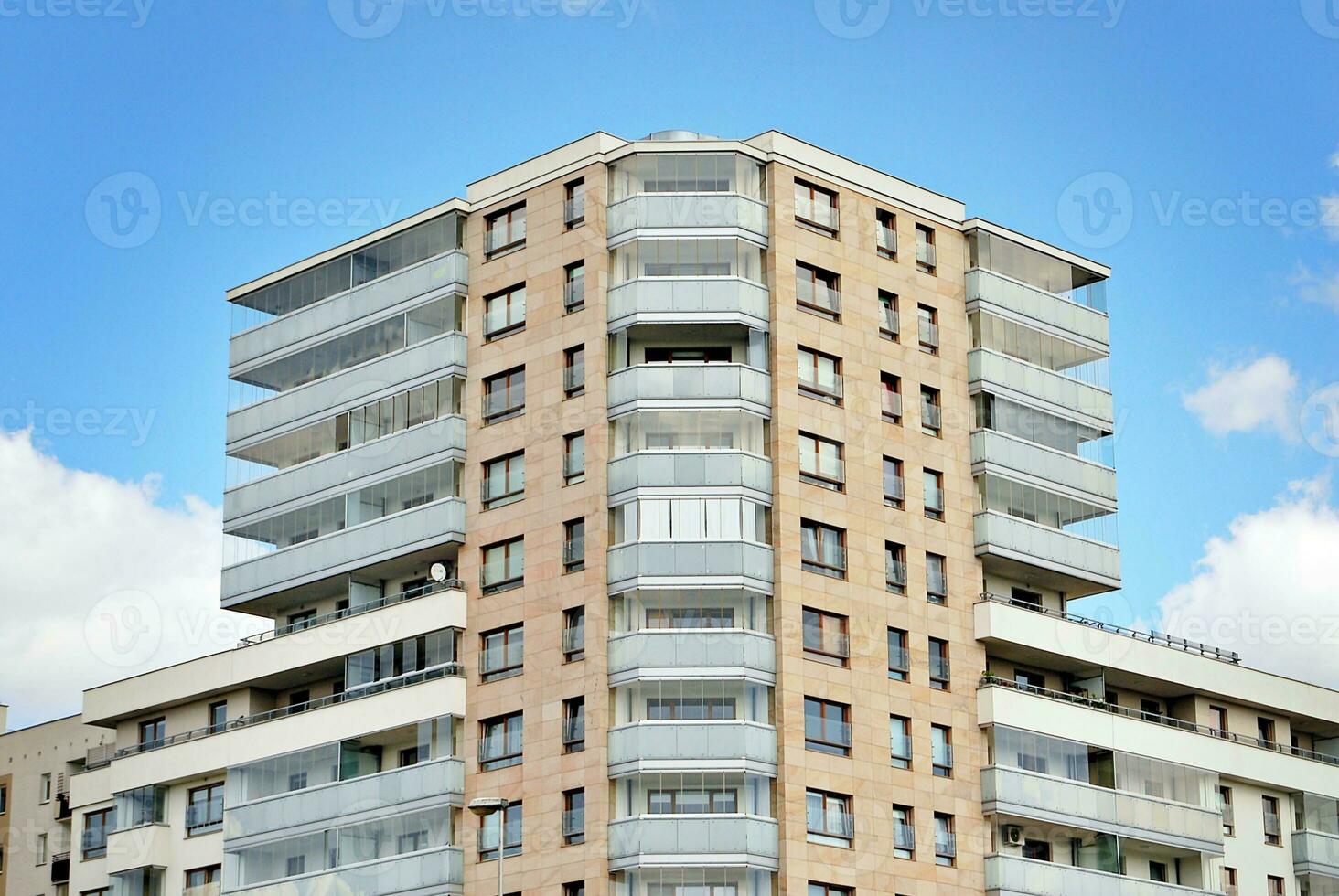 Modern apartment building in sunny day. Exterior, residential house facade. photo