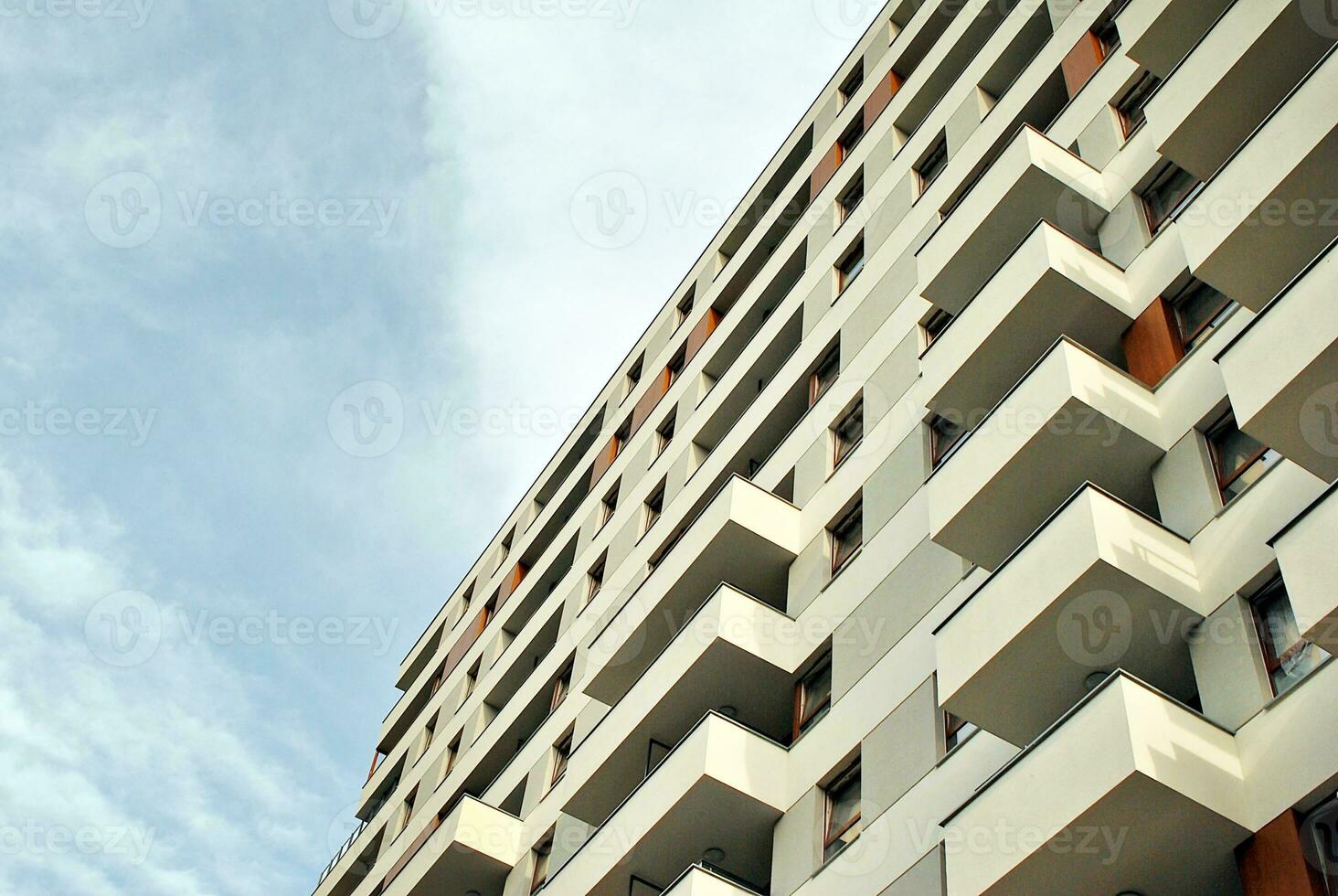 Modern apartment building in sunny day. Exterior, residential house facade. photo