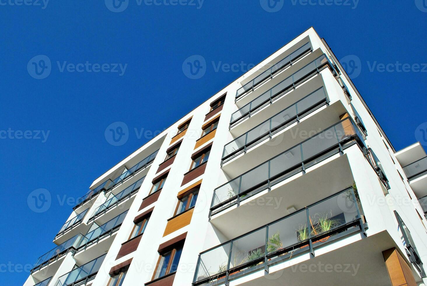 New apartment building with glass balconies. Modern architecture houses by the sea. Large glazing on the facade of the building. photo