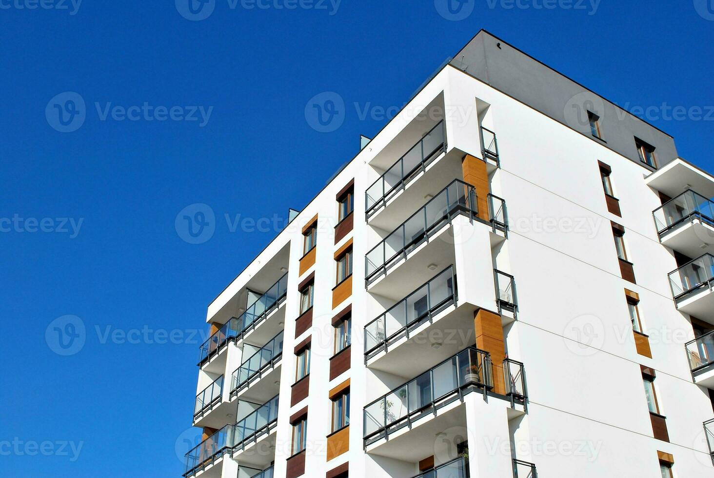 New apartment building with glass balconies. Modern architecture houses by the sea. Large glazing on the facade of the building. photo