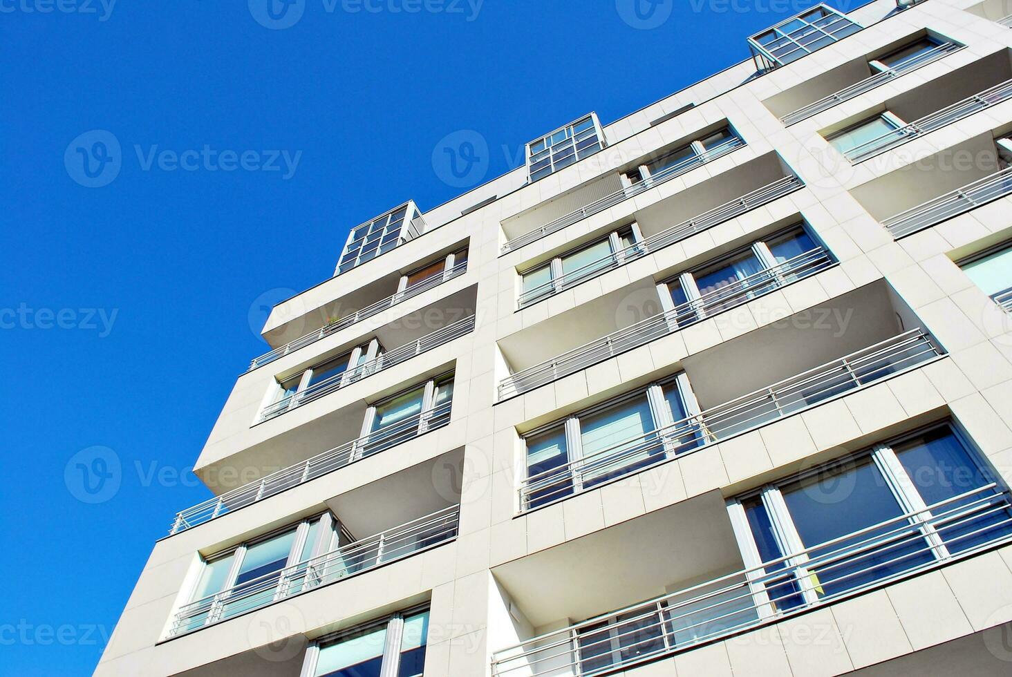 New apartment building with glass balconies. Modern architecture houses by the sea. Large glazing on the facade of the building. photo