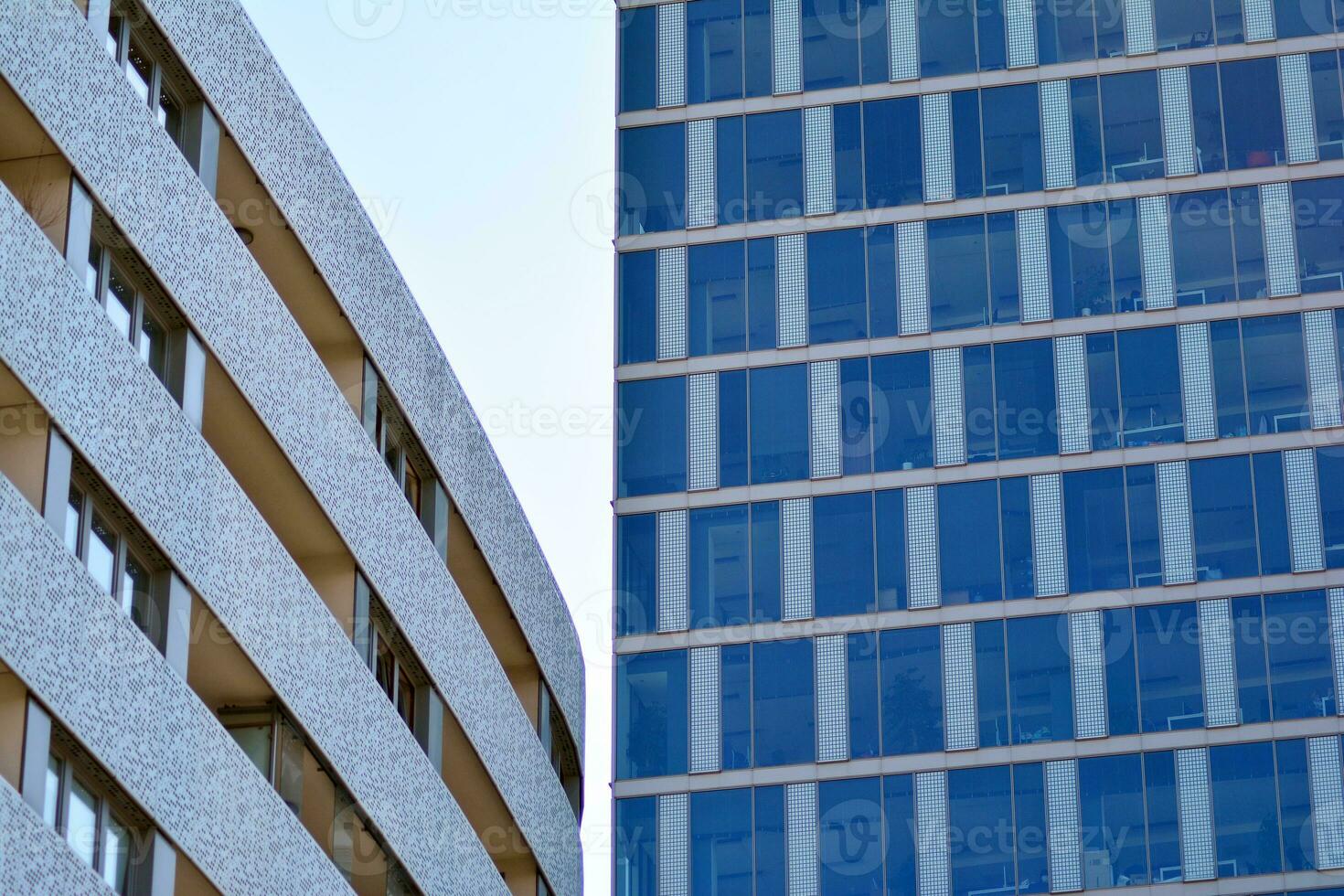 New apartment building with glass balconies. Modern architecture houses by the sea. Large glazing on the facade of the building. photo