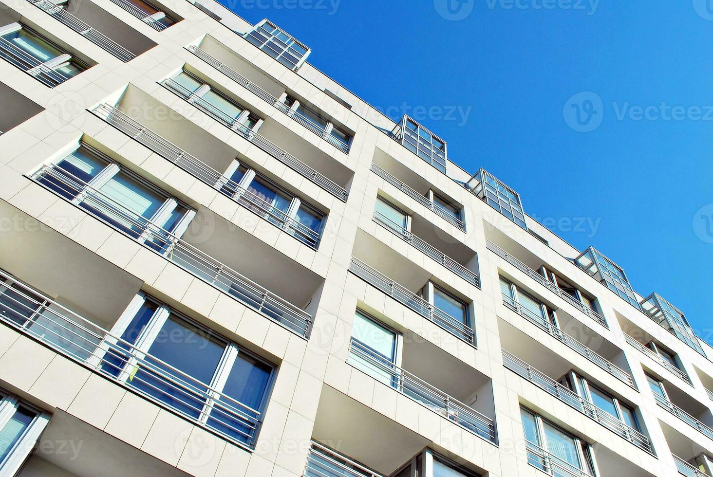 New apartment building with glass balconies. Modern architecture houses by the sea. Large glazing on the facade of the building. photo