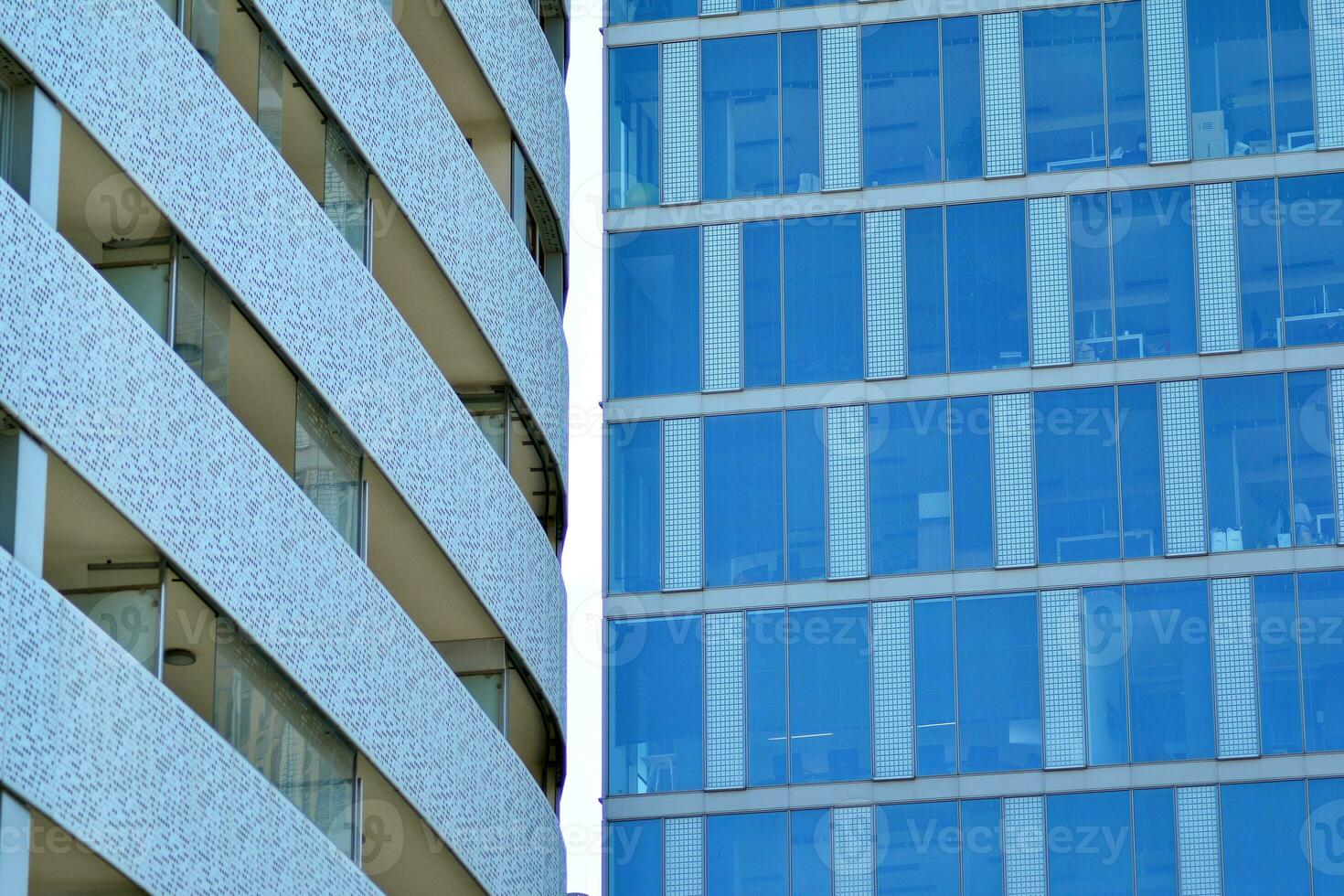 New apartment building with glass balconies. Modern architecture houses by the sea. Large glazing on the facade of the building. photo