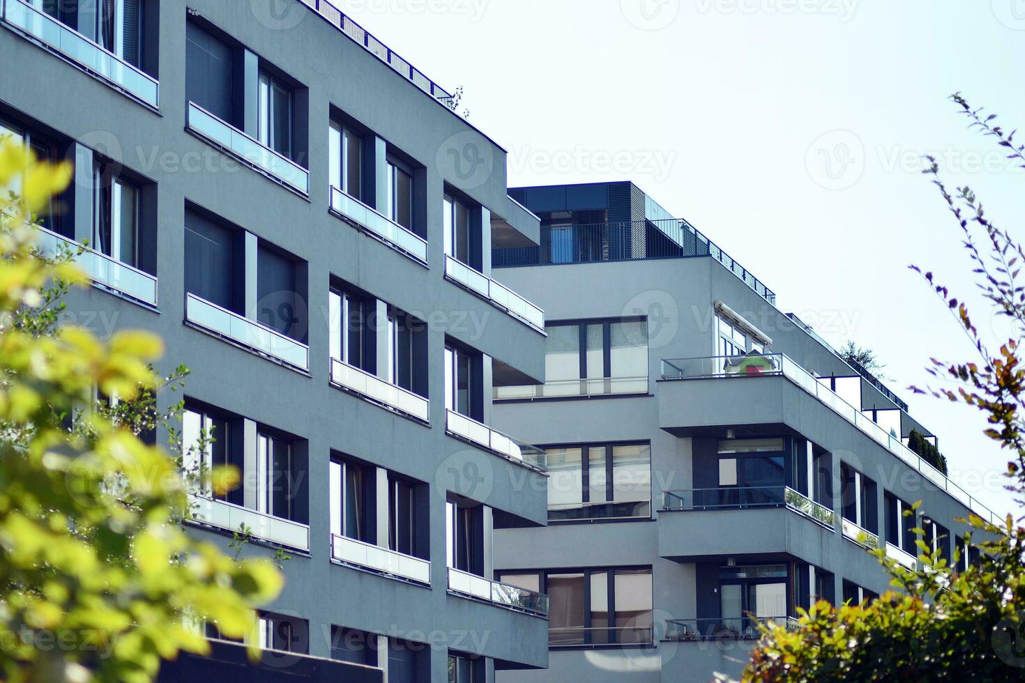 New apartment building with glass balconies. Modern architecture houses by the sea. Large glazing on the facade of the building. photo