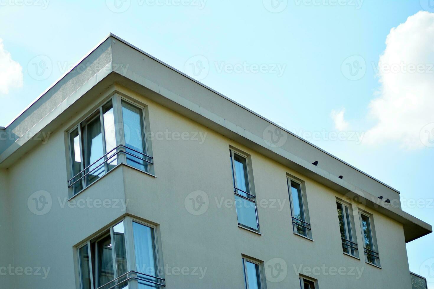 New apartment building with glass balconies. Modern architecture houses by the sea. Large glazing on the facade of the building. photo