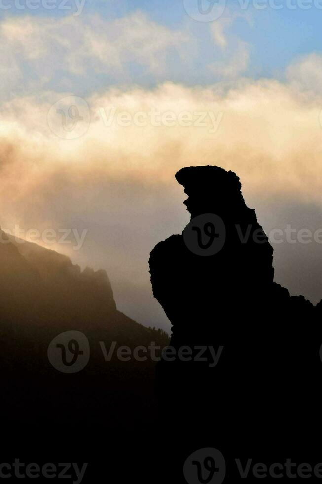 a silhouette of a mountain photo