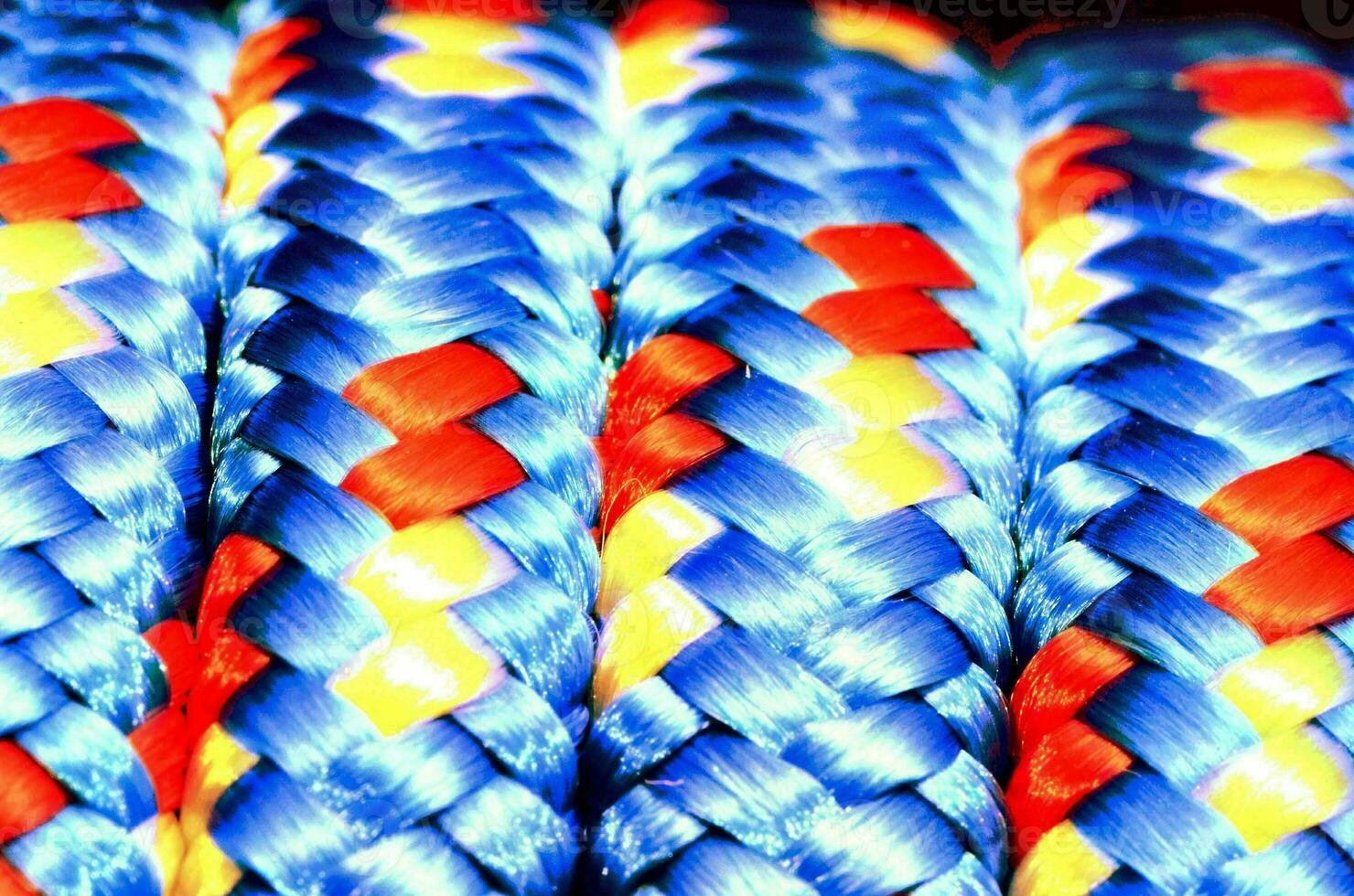 a close up of a blue, yellow and red braided rope photo