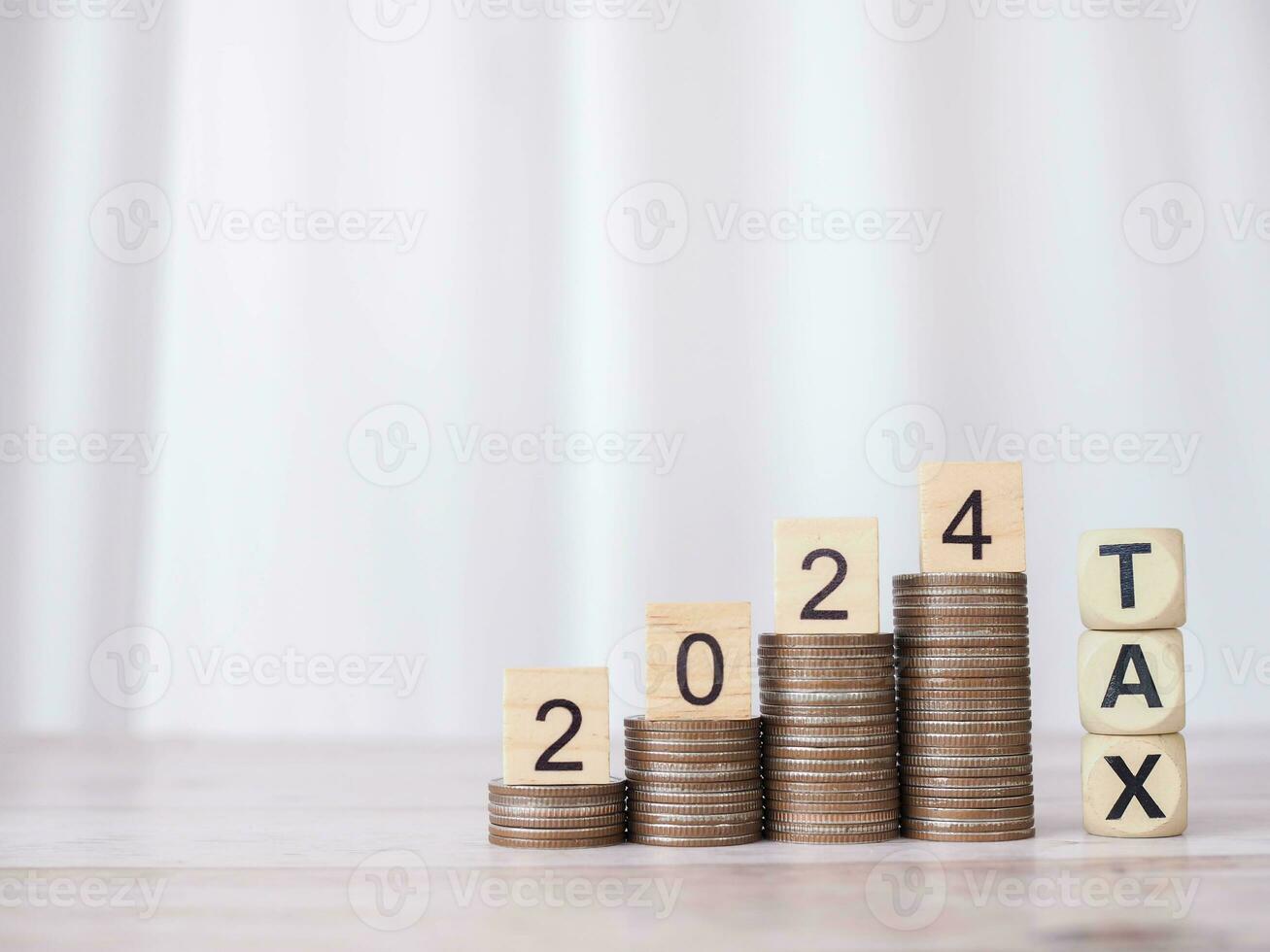 Wooden block with number 2024 on stack of coins and Wooden blocks with the word TAX. The concept of saving money for payment tax, Financial, Investment and Business growing in new year 2024. photo