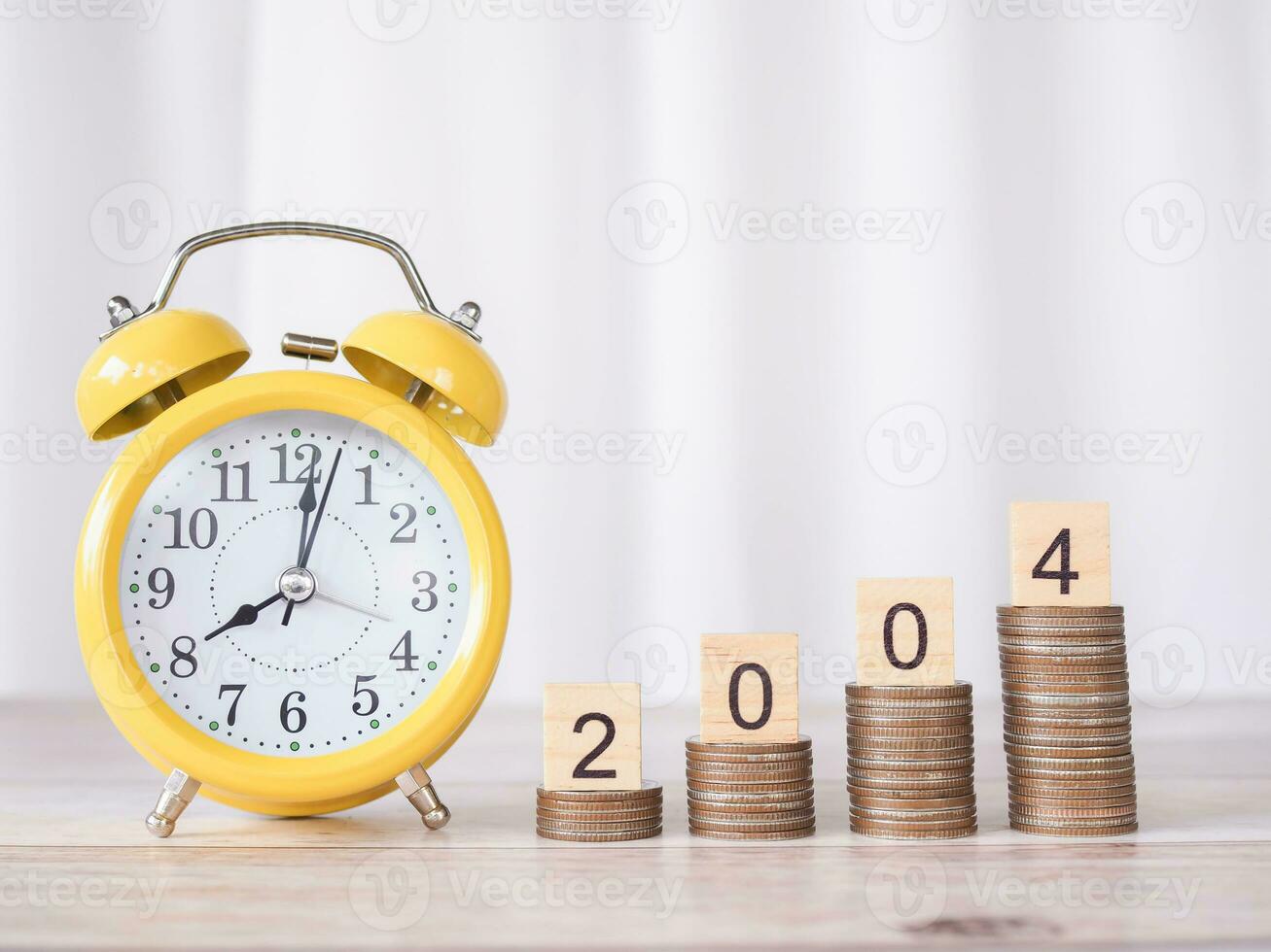 Yellow alarm and Wooden block with number 2024 on stack of coins. The concept of saving money, manage time to success Financial, Investment and Business growing in new year 2024. photo