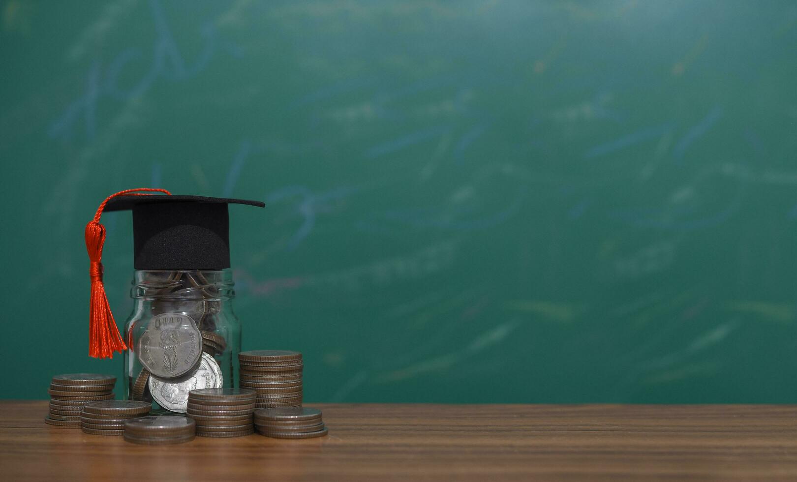 Glass bottle with graduation hat. The concept of saving money for education, student loan, scholarship, tuition fees in future photo