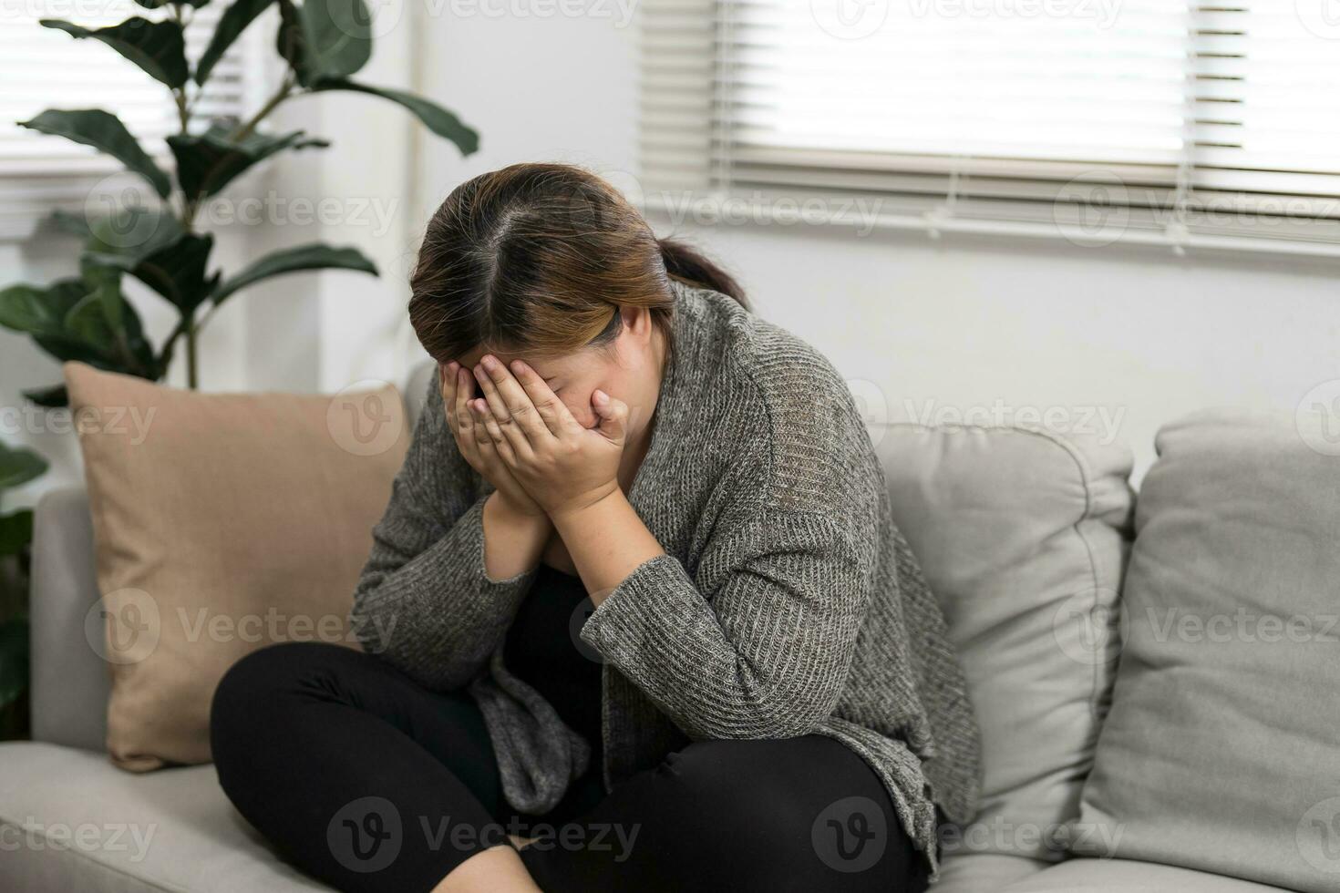 Sad Overweight plus size woman thinking about problems on sofa upset girl feeling lonely and sad from bad relationship or Depressed woman disorder mental health. photo