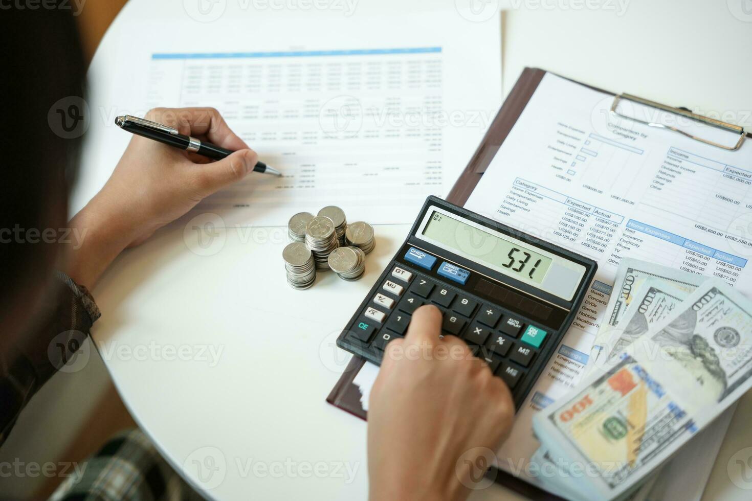 Saving money. Businessman Accountant verify growing business and saving money stacking coins with calculator. Accountancy Concept photo