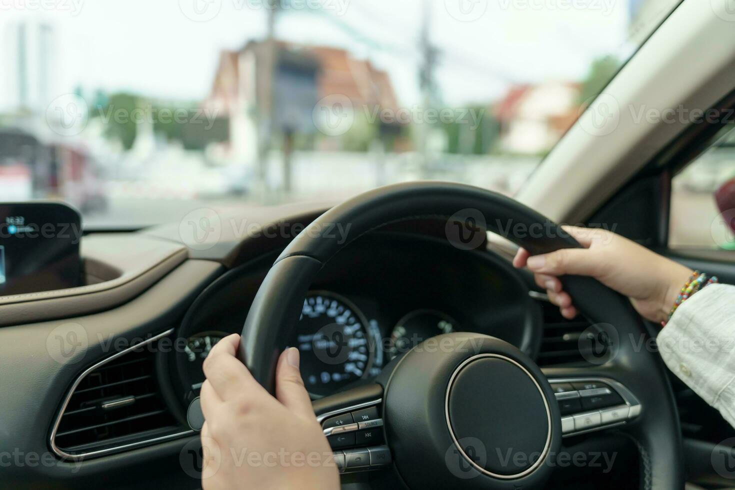 Woman driving car. girl feeling happy to drive holding steering wheel and looking on road photo