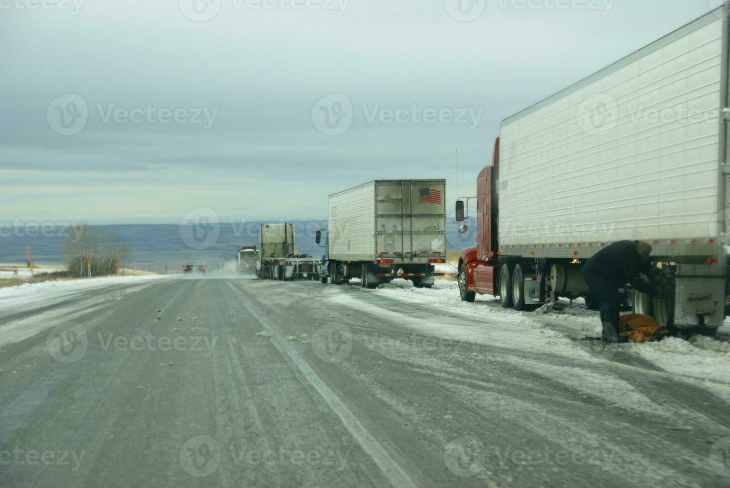 Trucks stop to remove chains photo