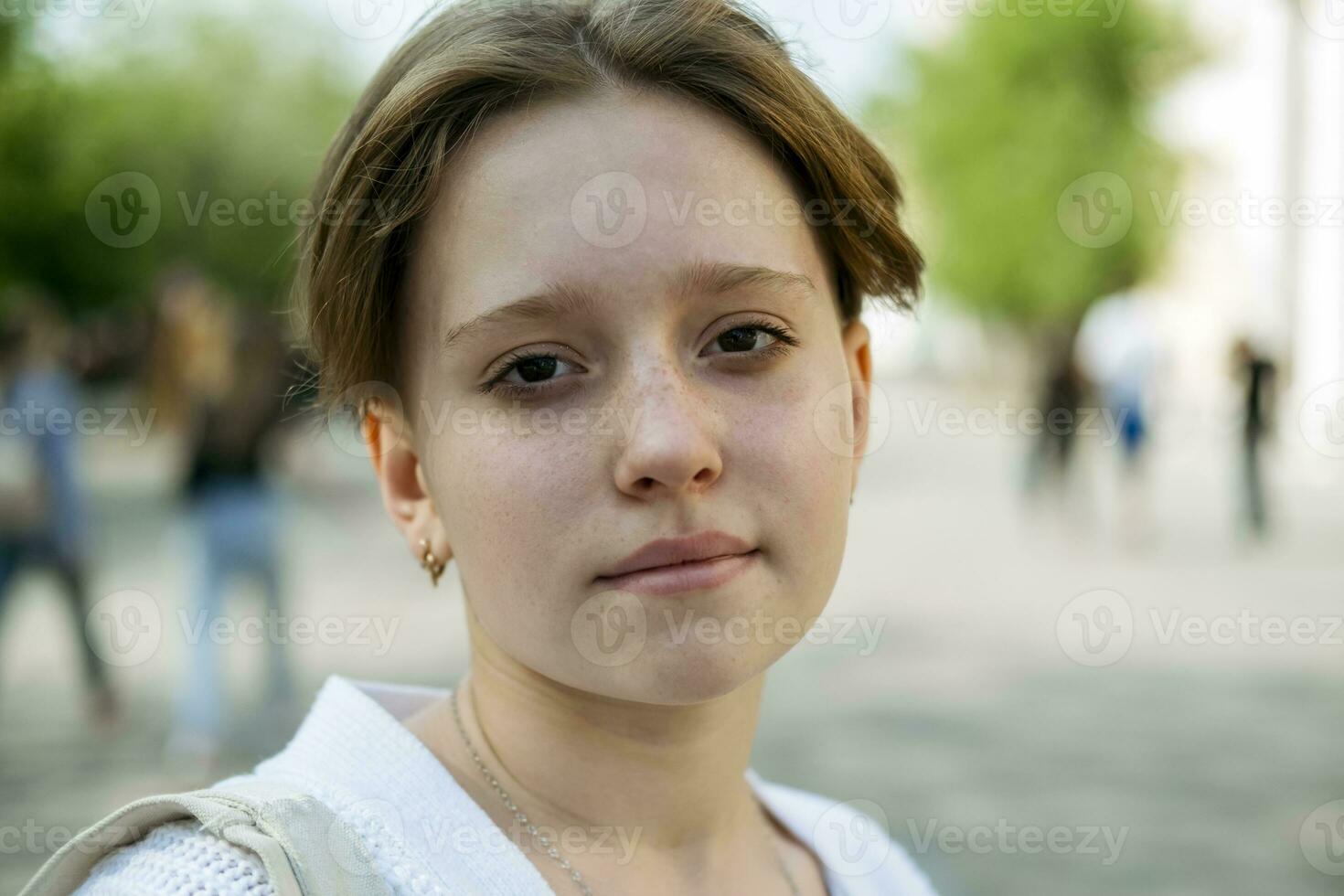 portrait of a teenage girl with short red hair radiates cool confidence, a snapshot of modern youth photo