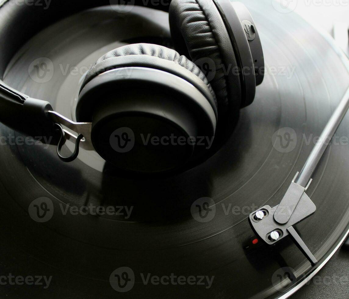 Black Headphones On Vinyl Disc Of Classic Turntable Detailed Top View photo
