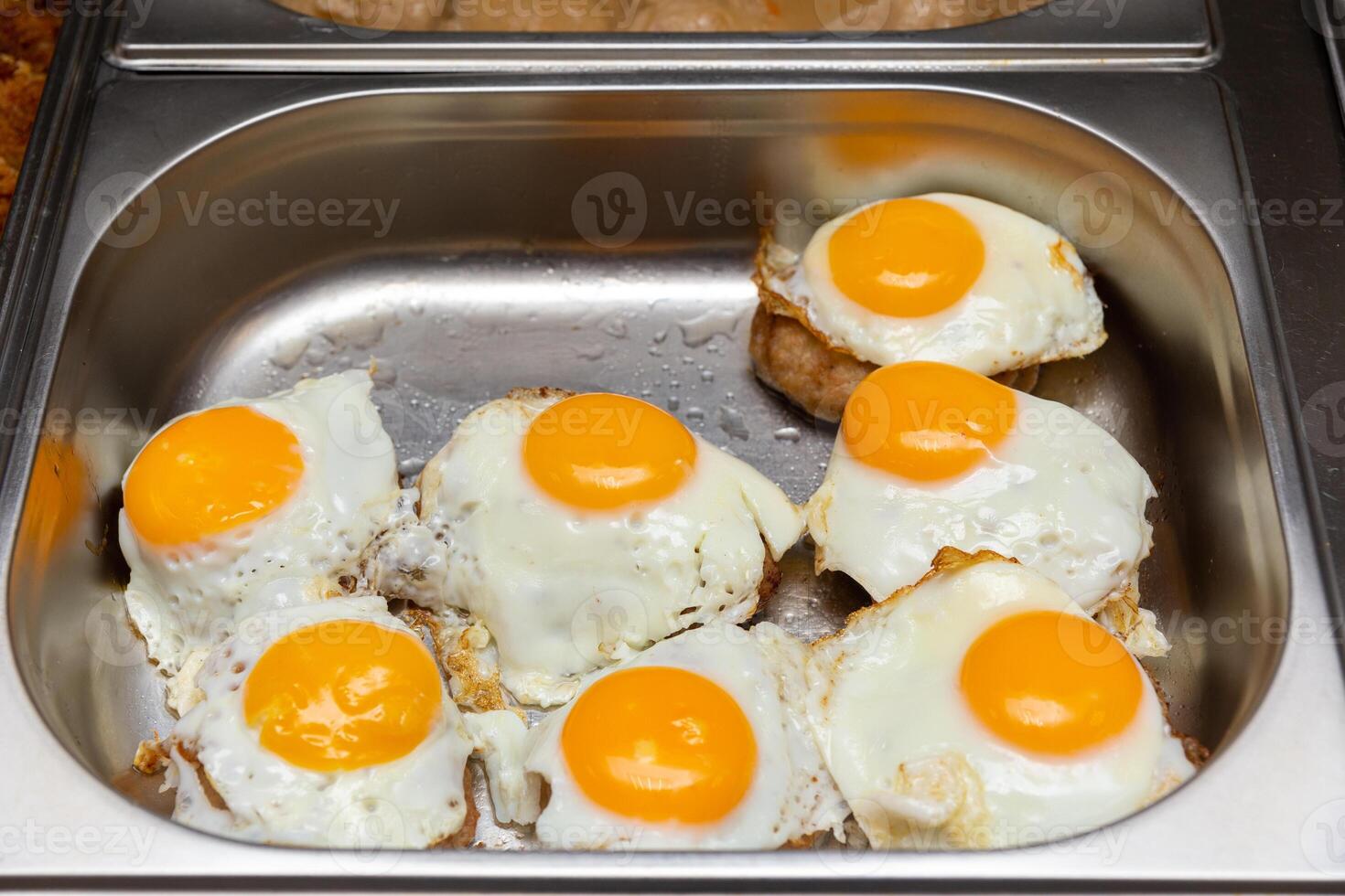 Beef Steaks with fried egg in stainless steel tray. photo