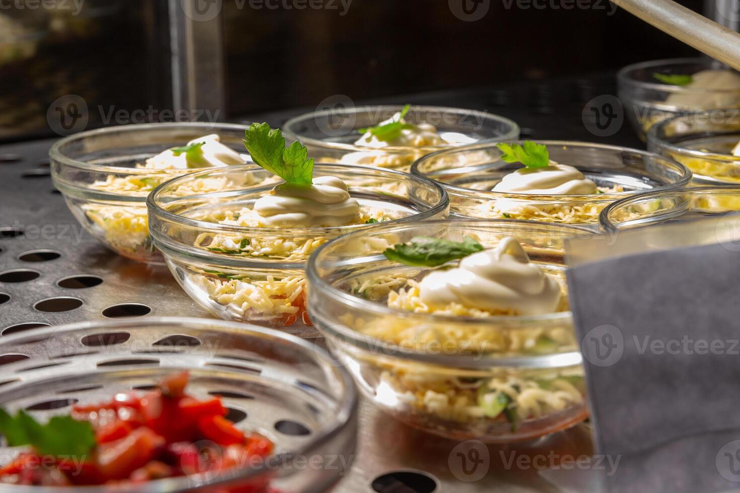 Plates with various pastries in the cafeteria window. photo