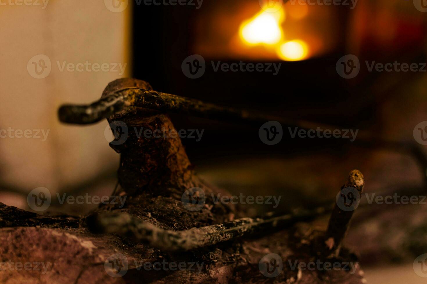Fire in a fireplace in the living room with accessories photo