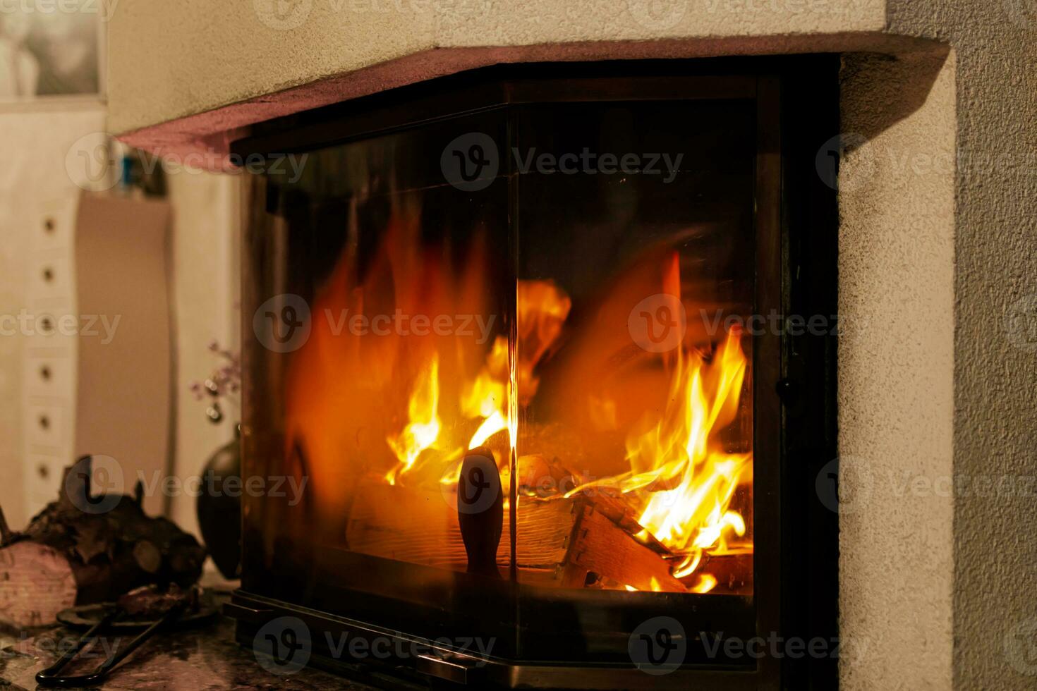 Fire in a fireplace in the living room with accessories photo