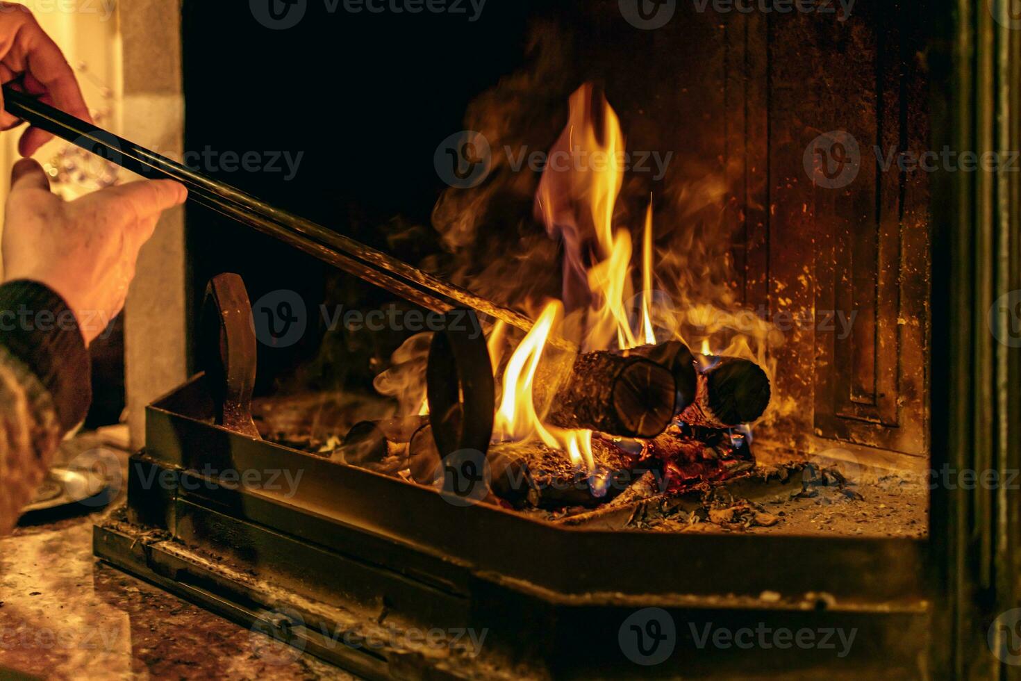 Fire in a fireplace in the living room with accessories photo