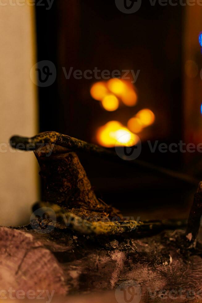 Fire in a fireplace in the living room with accessories photo