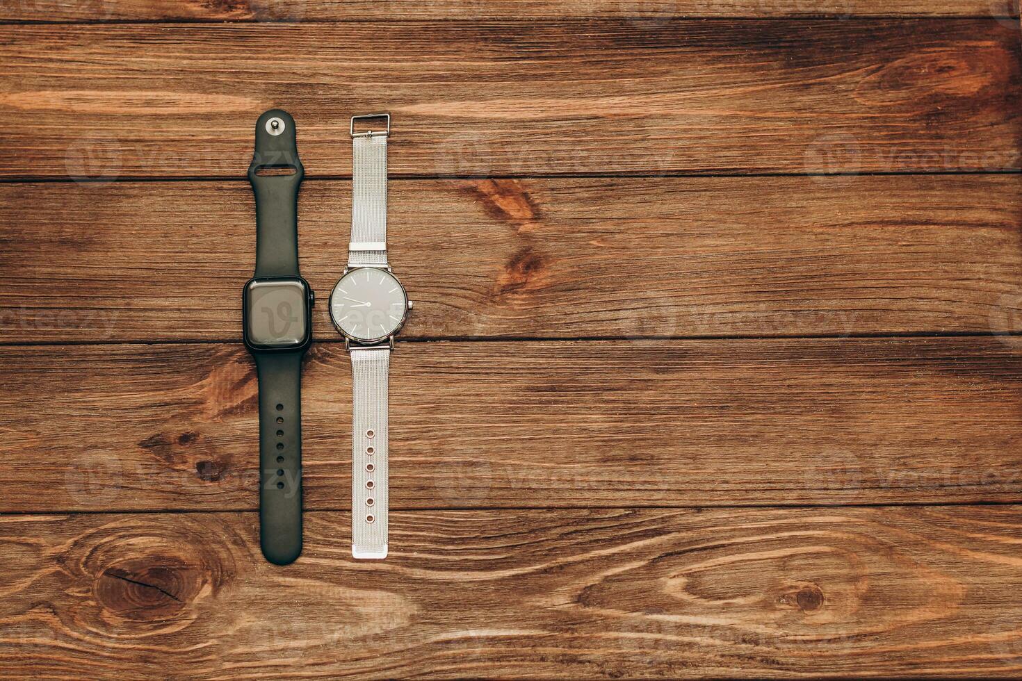Black technological smart watches and ordinary mechanical watches with a dial. photo