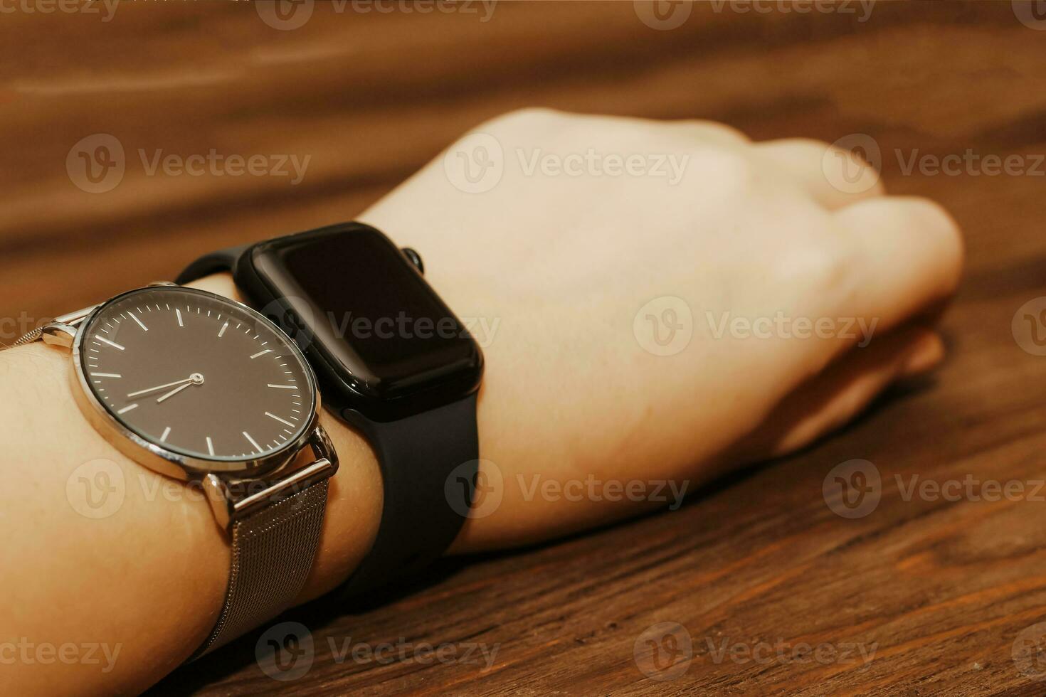 Black technological smart watches and ordinary mechanical watches with a dial. photo
