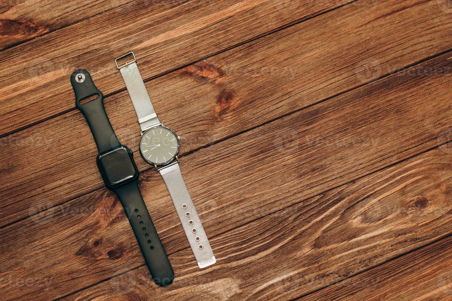 Black technological smart watches and ordinary mechanical watches with a dial. photo