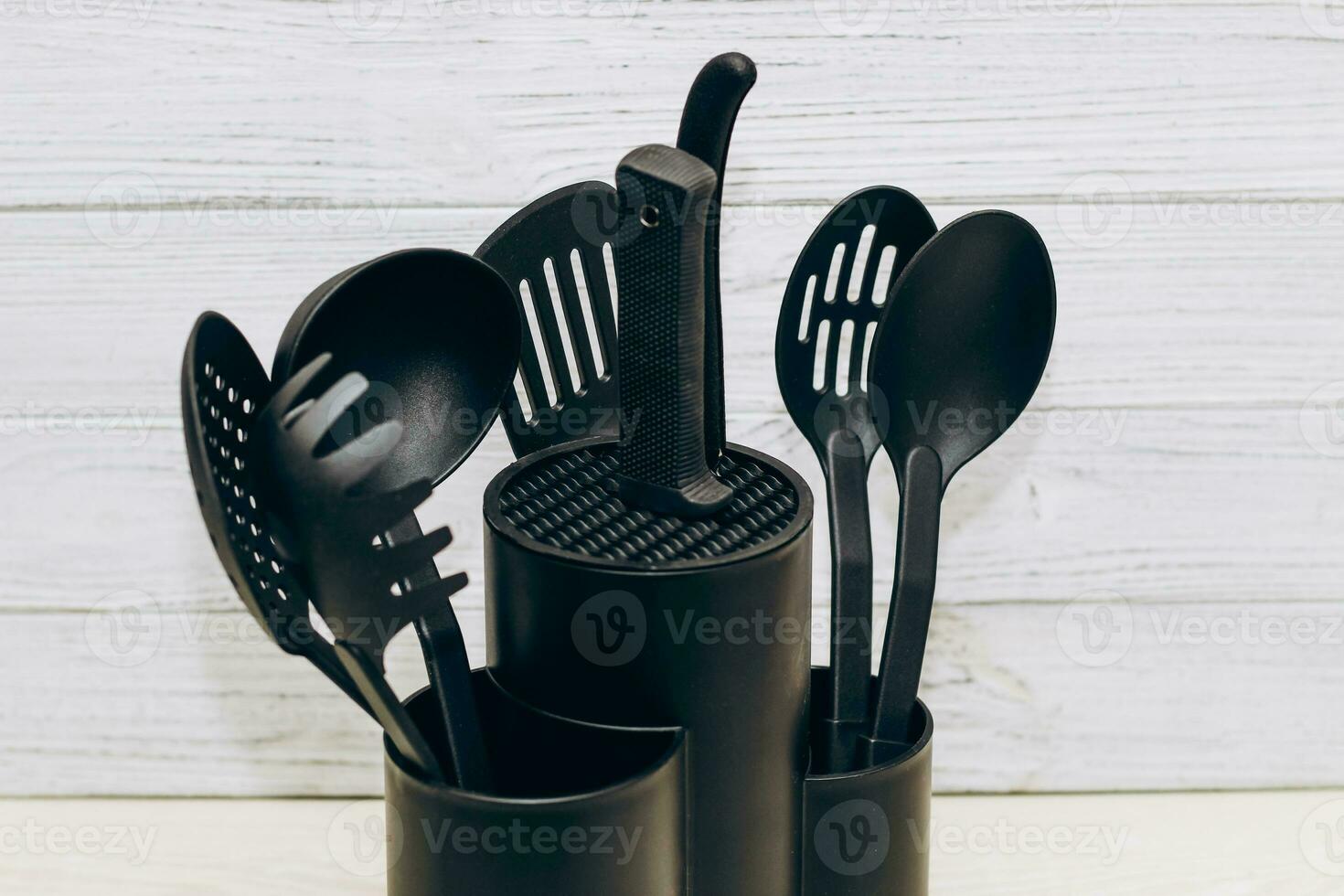 Kitchen tools plastic for multicooker on a wooden table in a dish organizer. photo