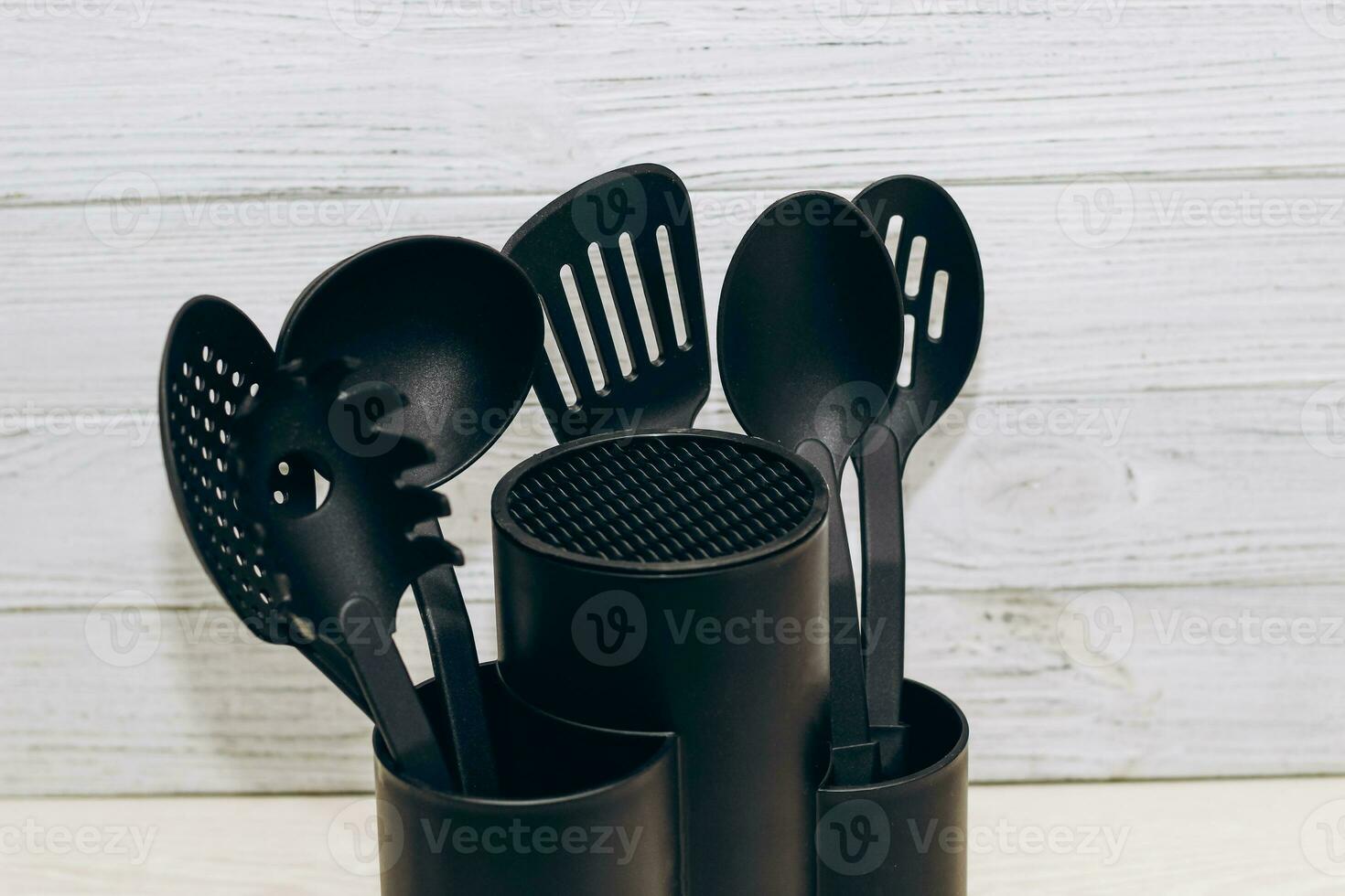 Kitchen tools plastic for multicooker on a wooden table in a dish organizer. photo