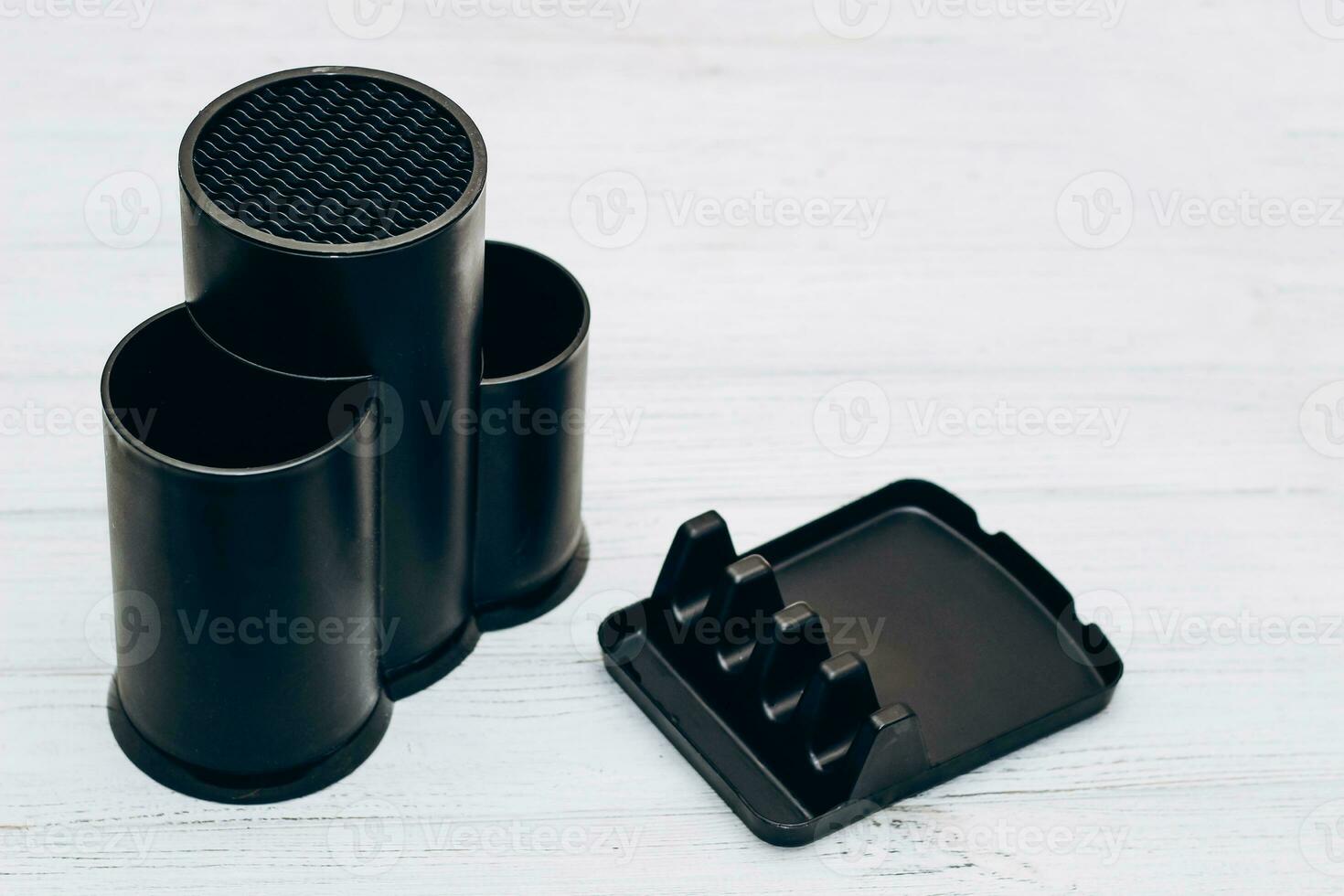 Plastic black coaster for dishes, a handy thing in the kitchen, space organization. photo