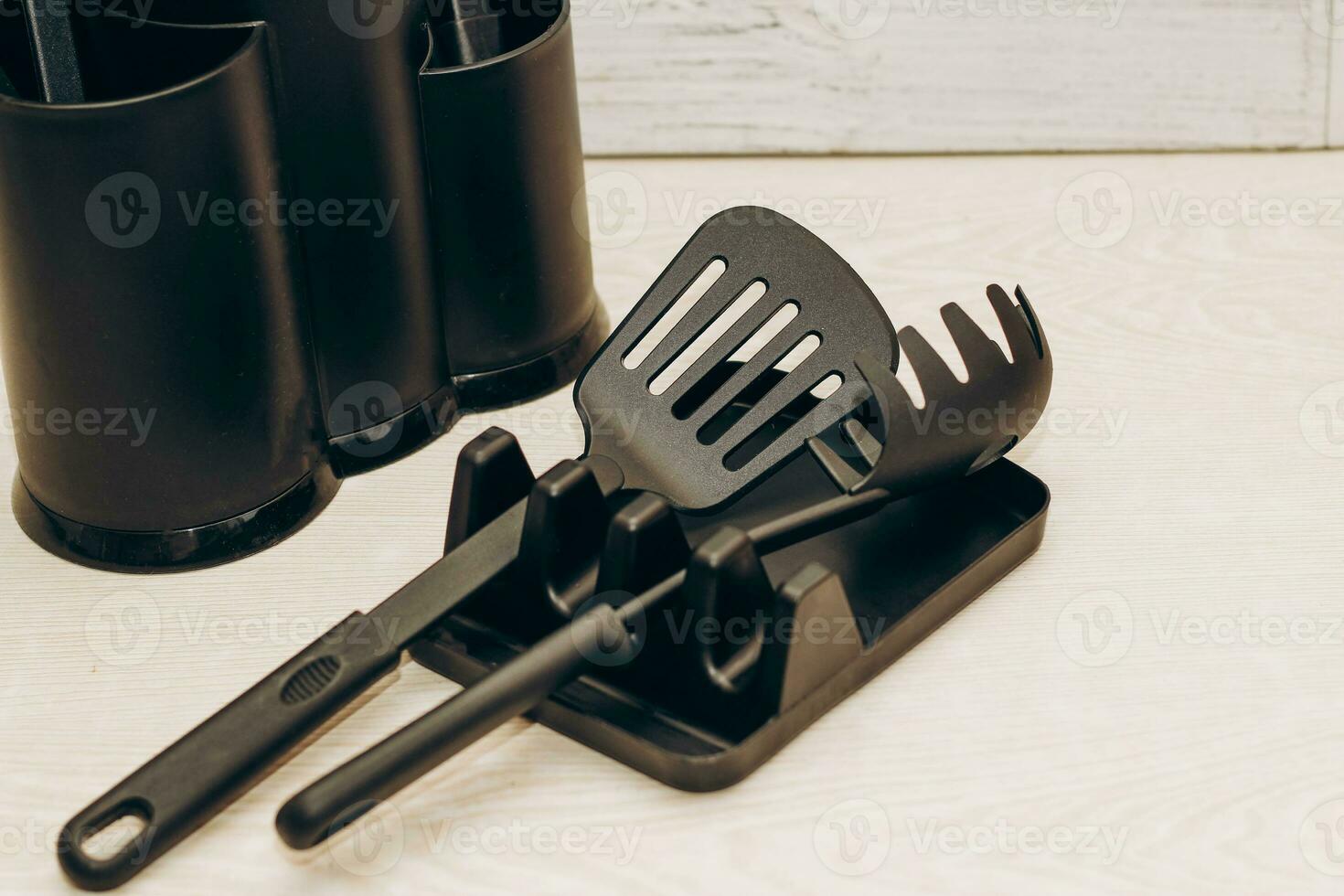 Kitchen tools plastic for multicooker on a wooden table in a dish organizer. photo