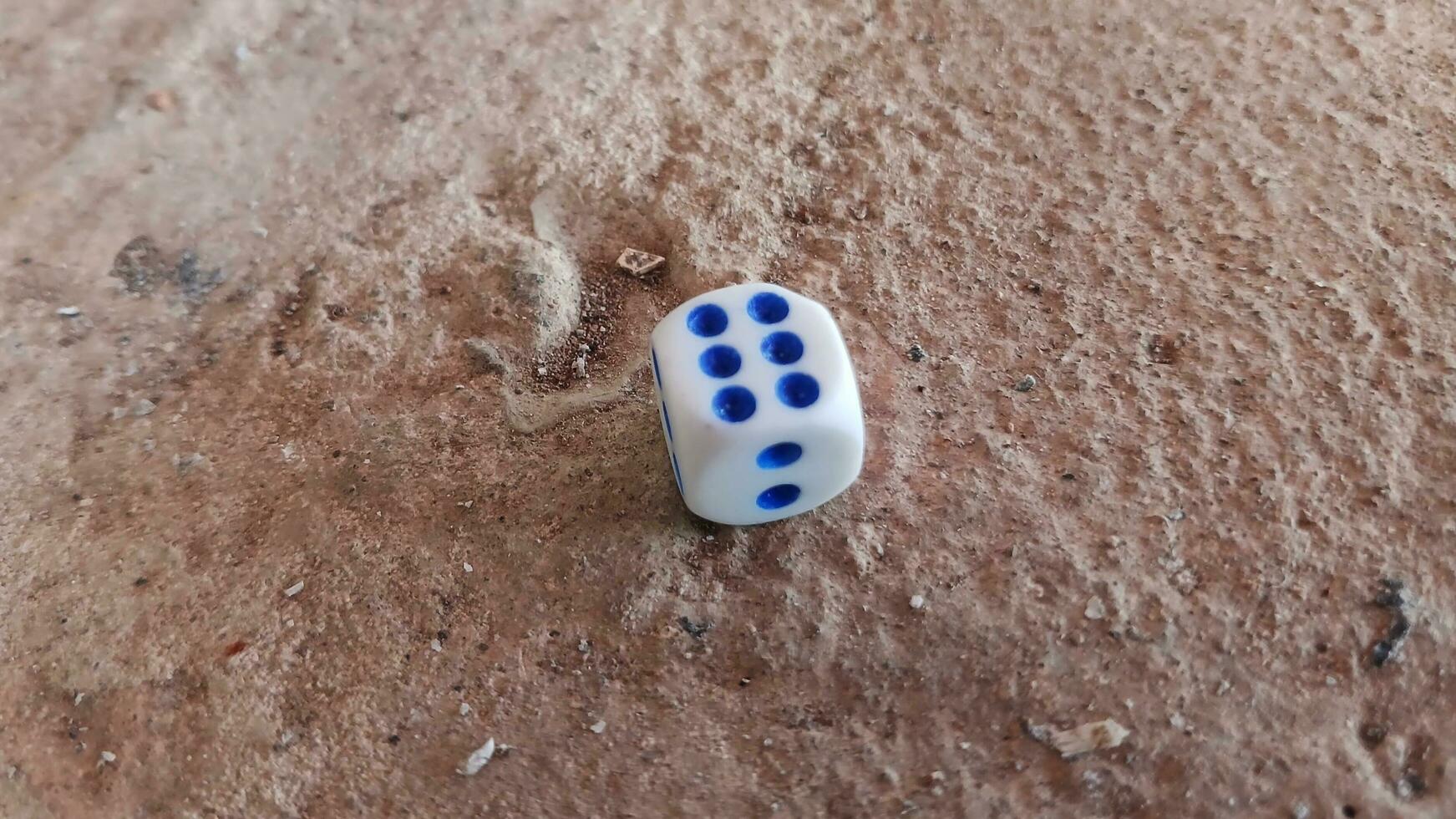 Dice placed on concrete floor surface, selective focus. photo