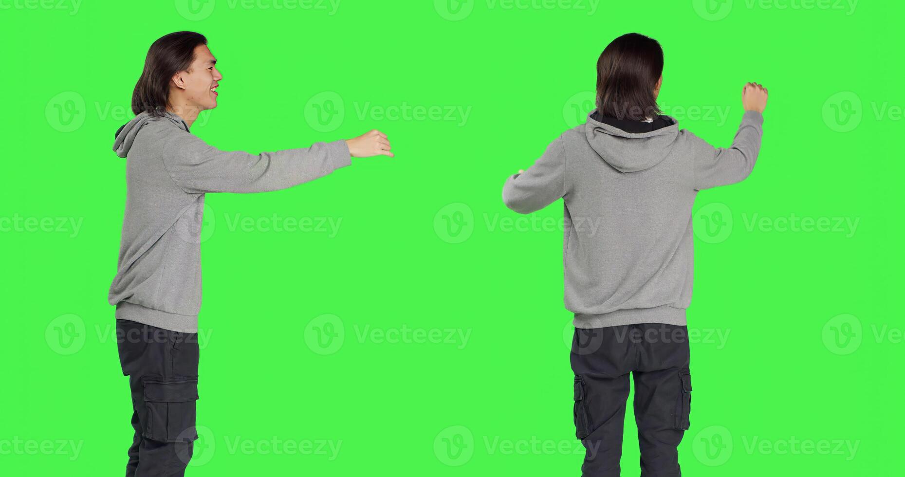 Asian man being choir chief director at musical show, moving hands like a choirmaster over greenscreen background. Young model conducting band to sing, smiling conductor bandmaster. photo