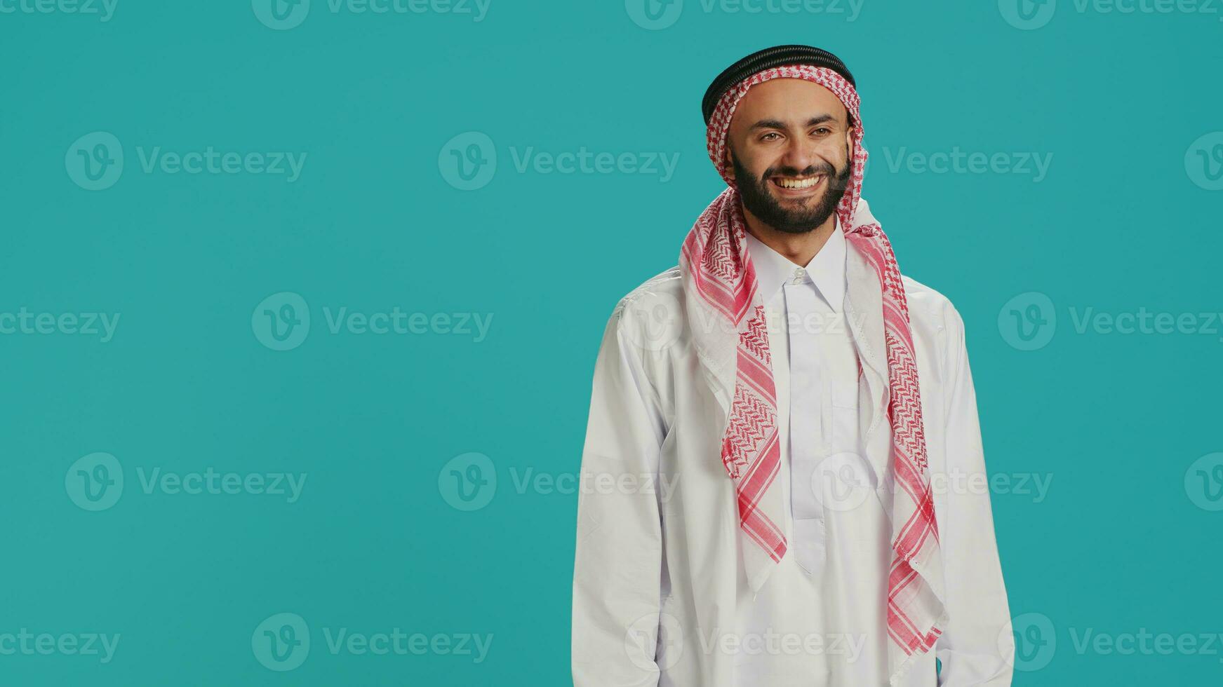 Young muslim man saying yes nodding on camera, presenting agreement symbol and support about something. Middle eastern guy showing positivity and happiness, giving his approval. photo