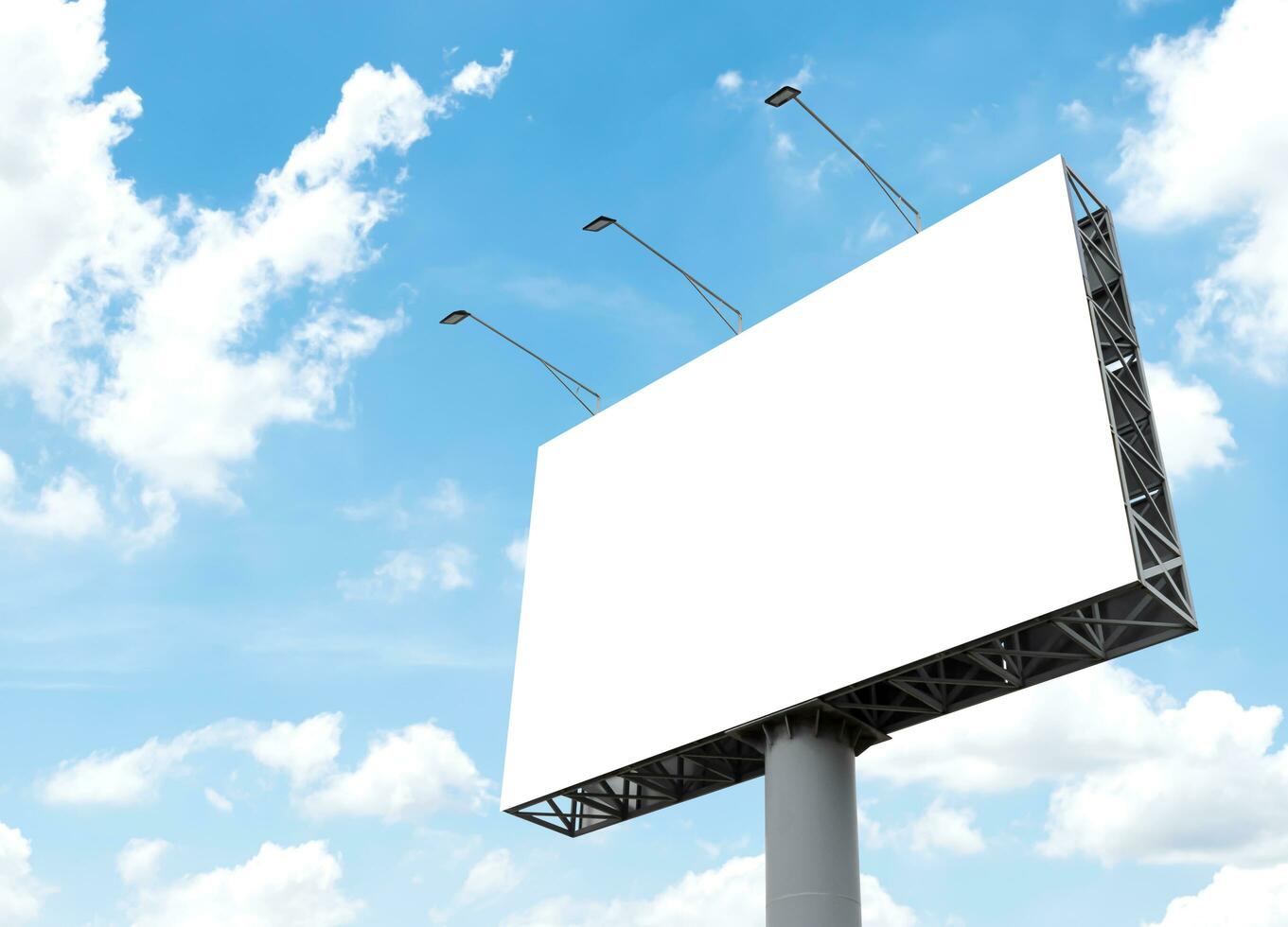 Pole outdoor billboard with blue sky background. Clipping path for mockup white screen photo