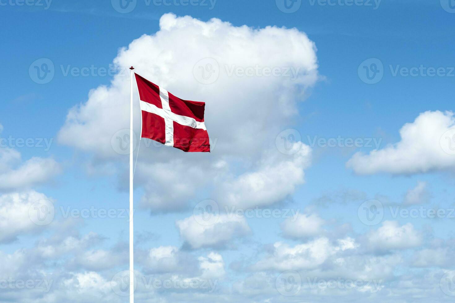 Flag of Denmark against blue sky photo