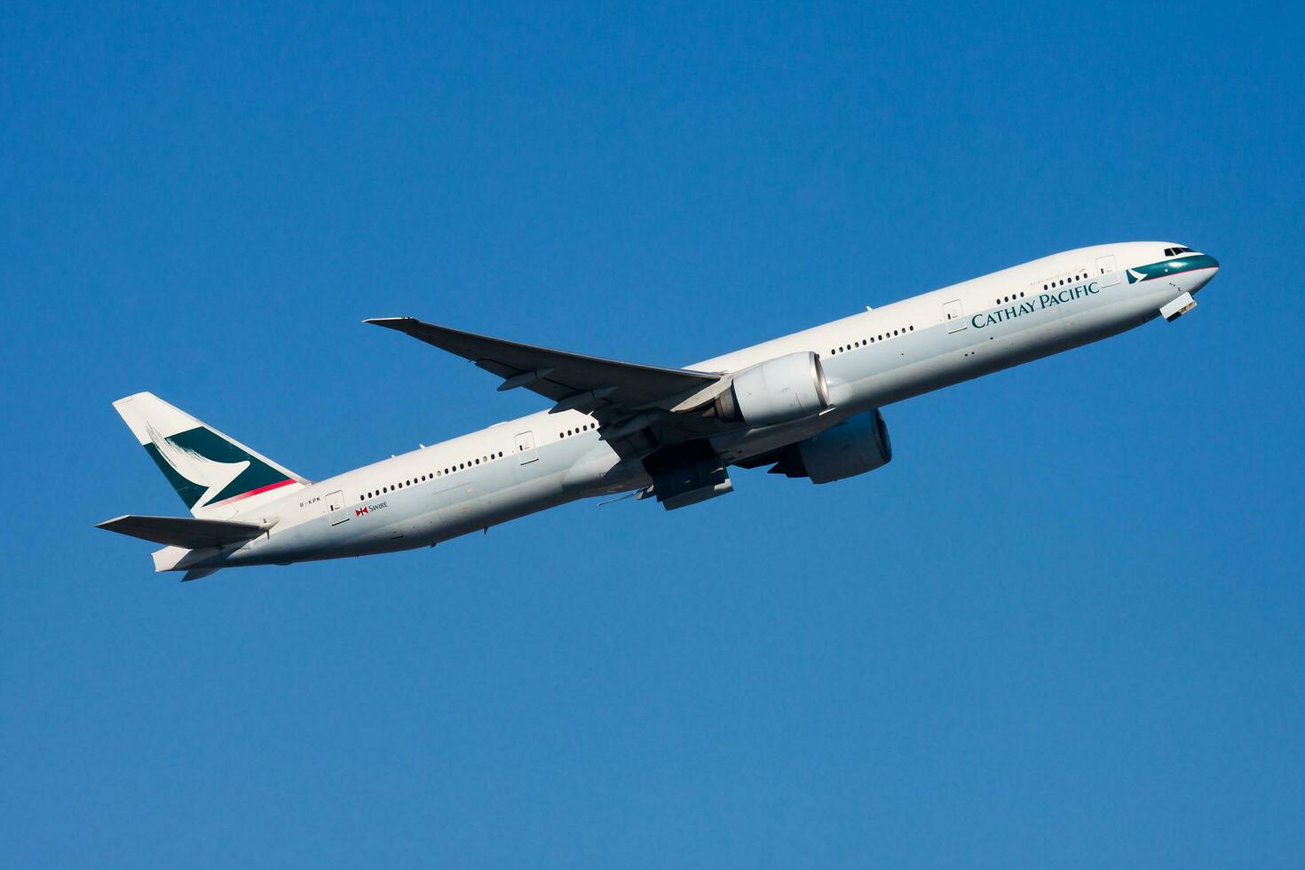 Hong Kong, China, 2013 - Cathay Pacific Airways Boeing 777-300ER B-KPK passenger plane departure and take off at Hong Kong Chek Lap Kok Airport photo