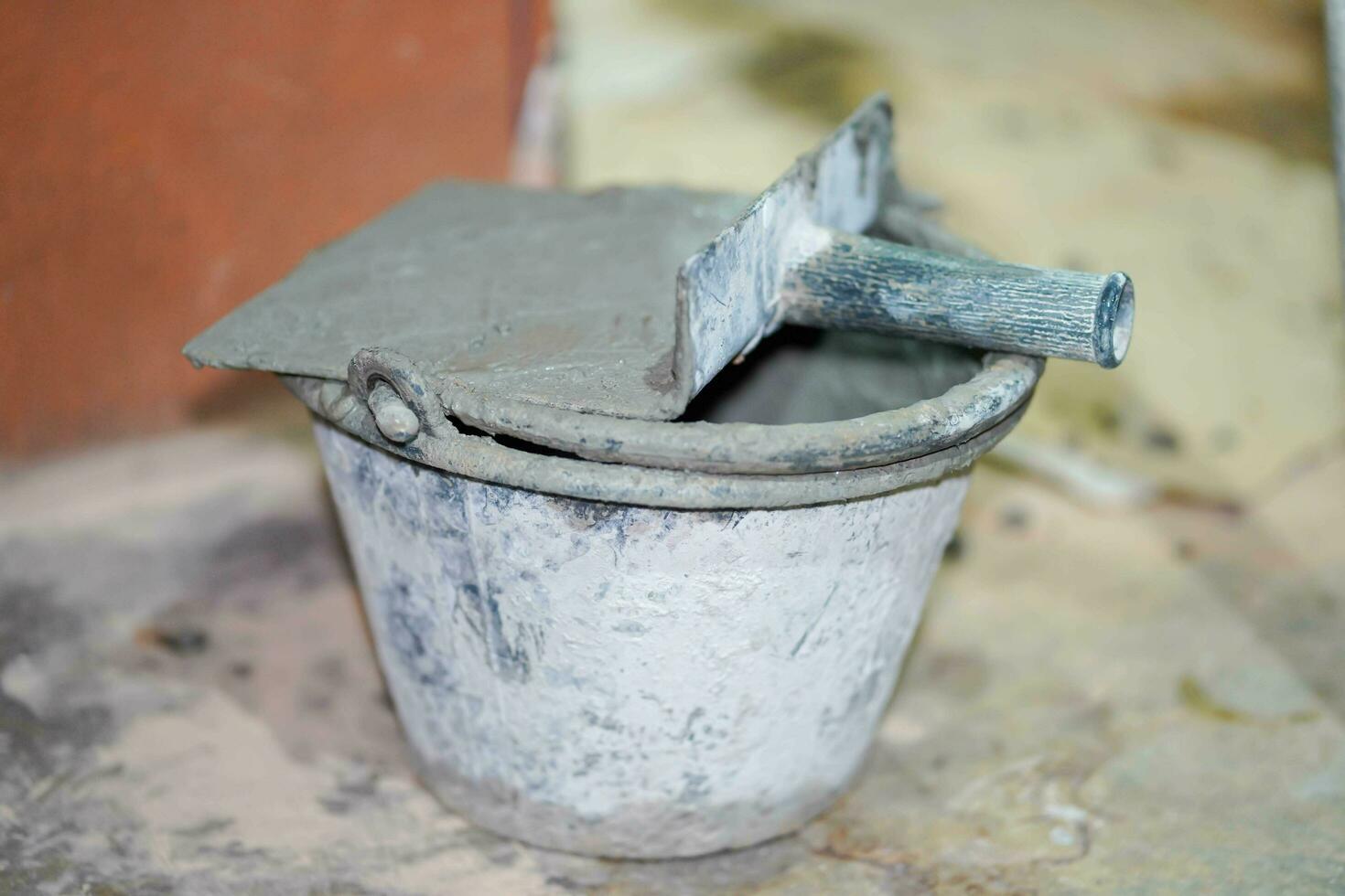 Closeup mortar pan for plastering walls with cement bucket in construction site. photo