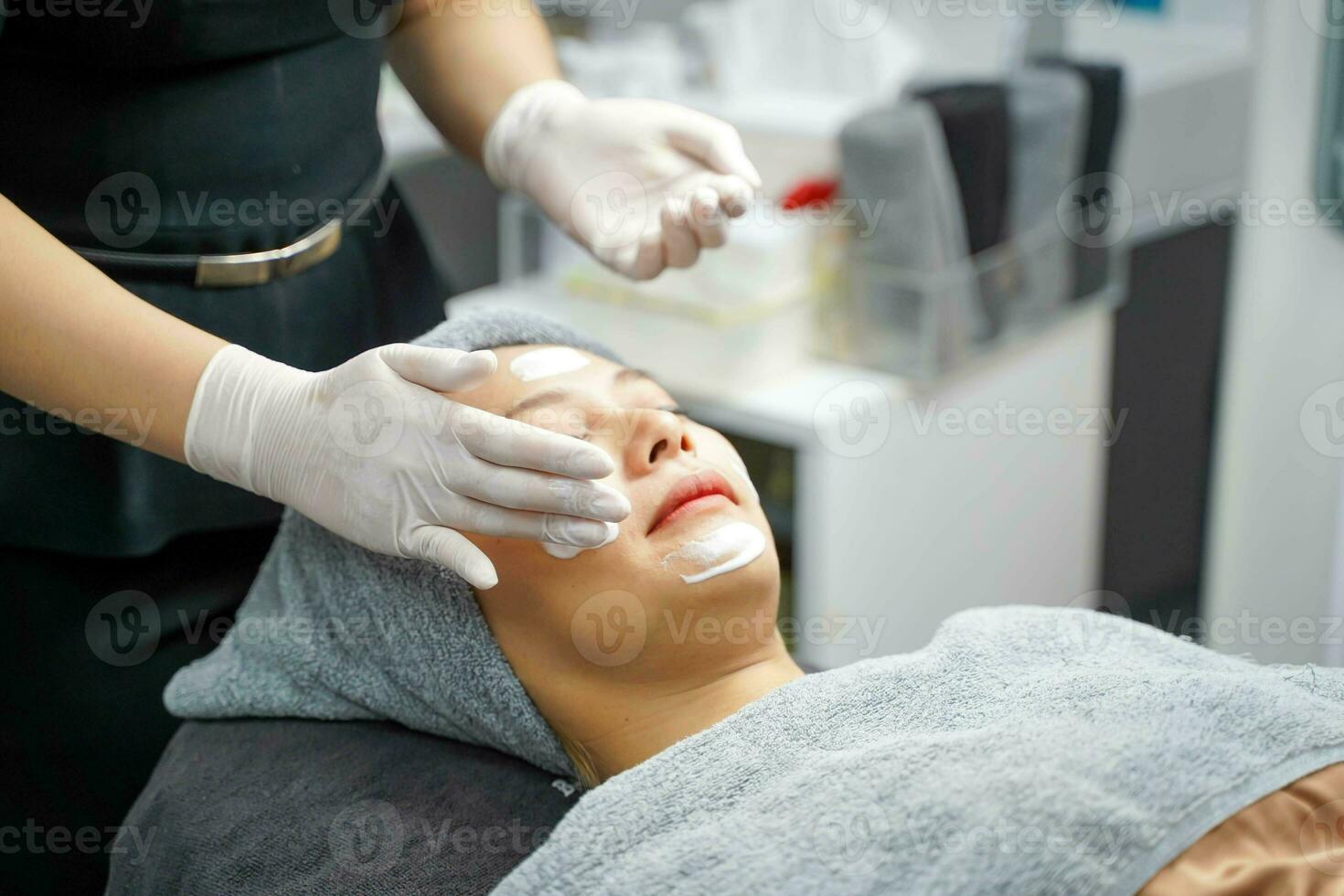 Young beauty woman in towel making facial massage with organic face scrub. photo