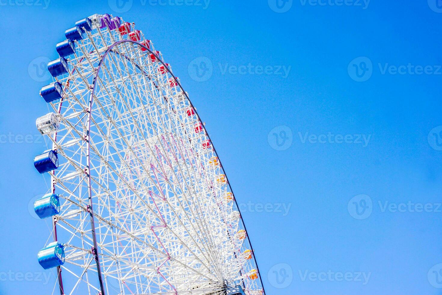 Closeup and crop Tempozan Giant Ferris Wheel on bright blue sky background with space for texts. photo