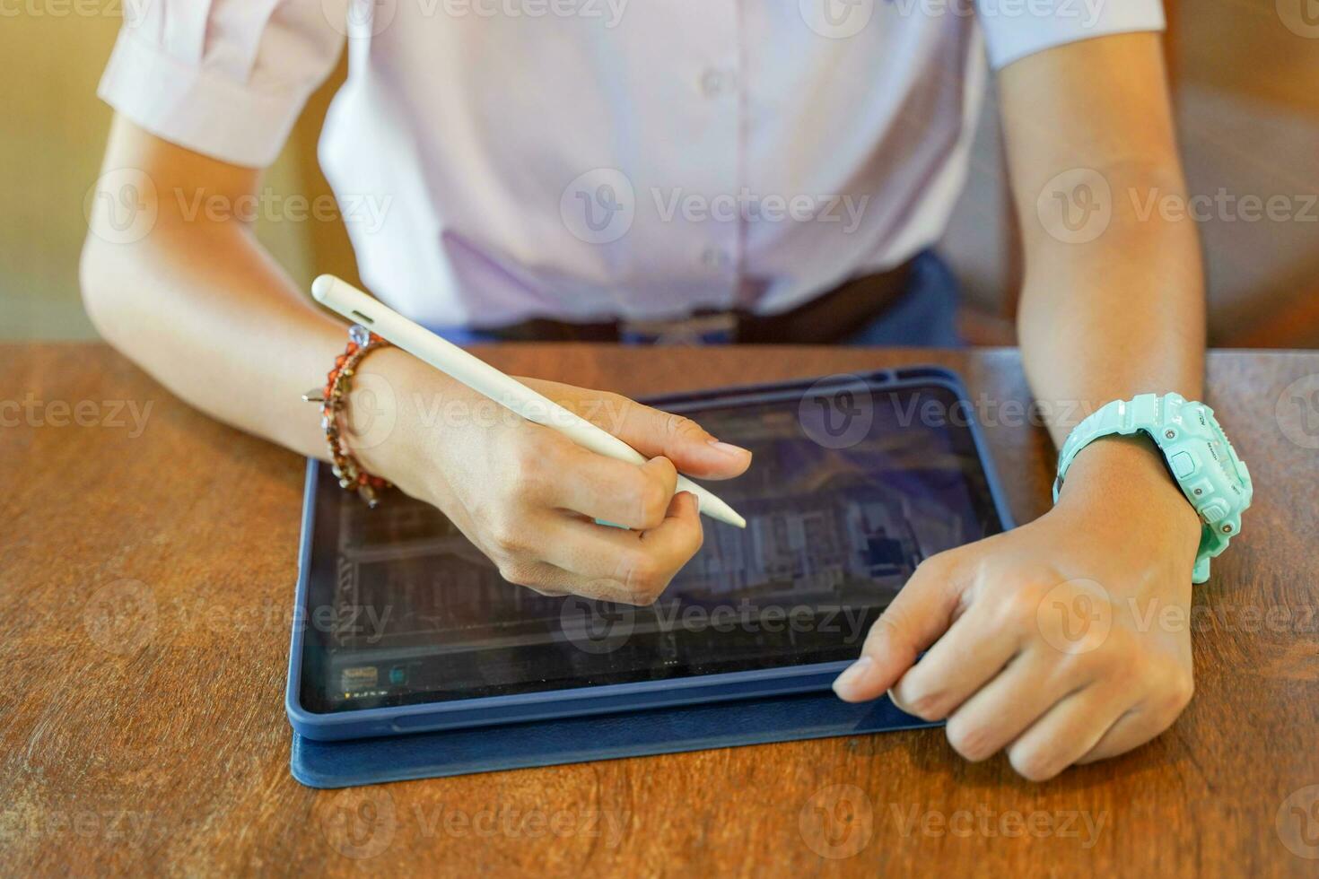 Closeup and crop hands of Student using and study on tablet at school with sun flare background. Network education concept. photo